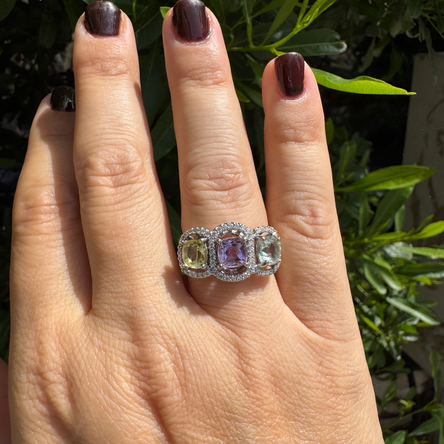 18K gold ring set with three pastel gemstones in soft shades of lilac, yellow and light gray