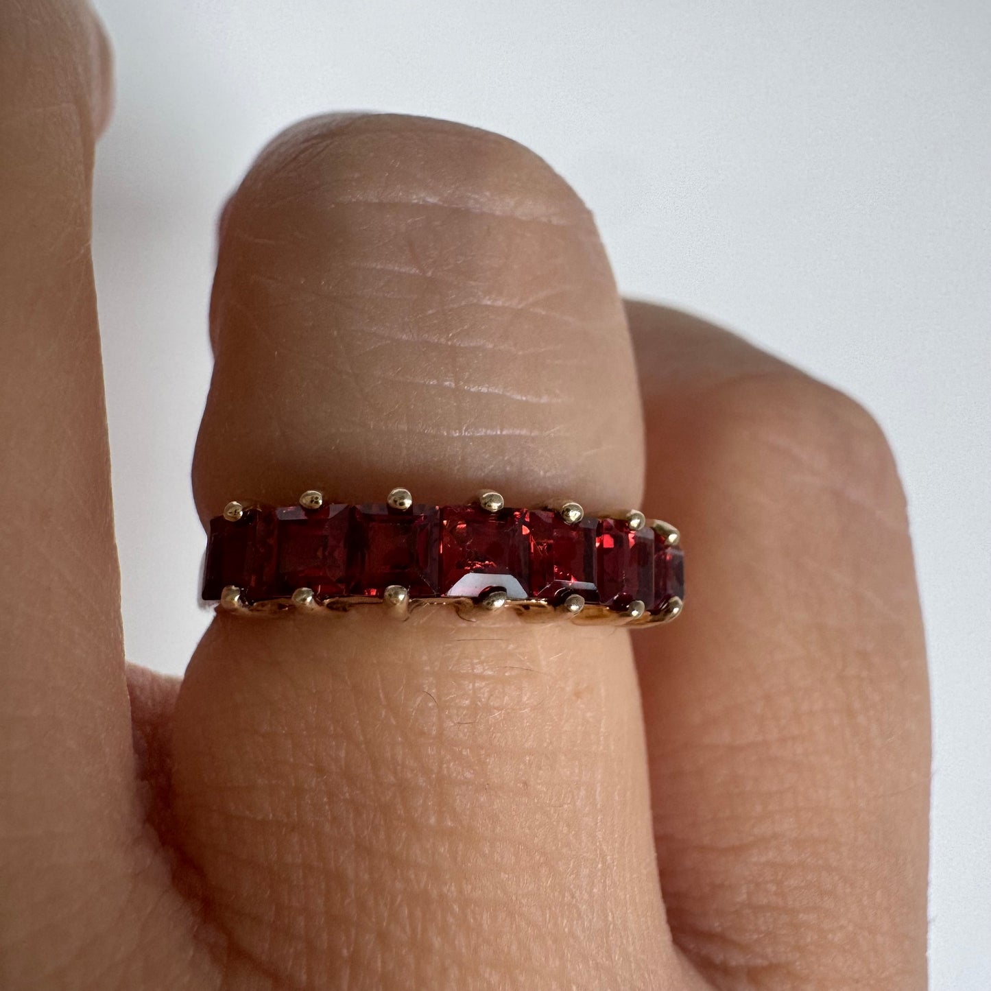 9K gold ring set with deep red garnets