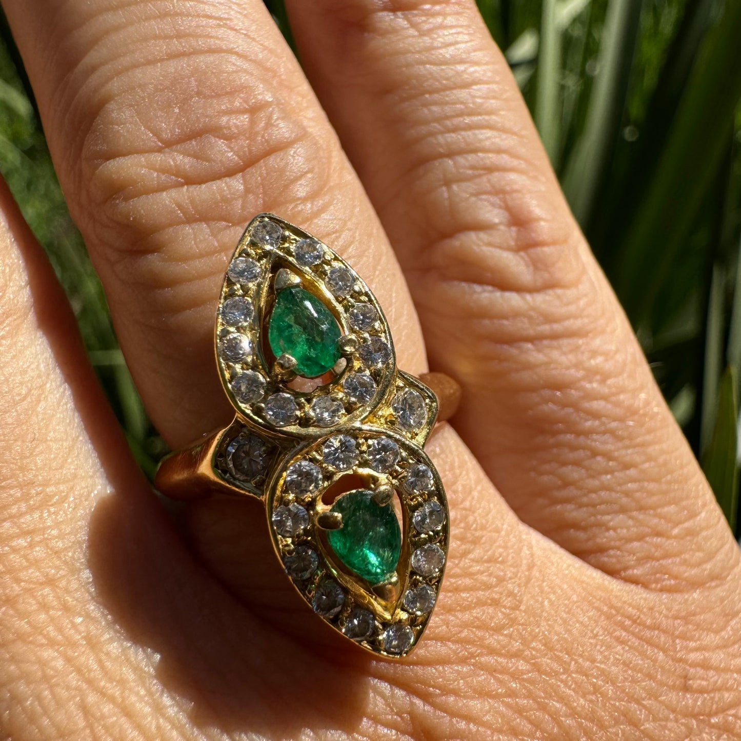 18K gold ring set with two pear-cut Emeralds & Diamonds
