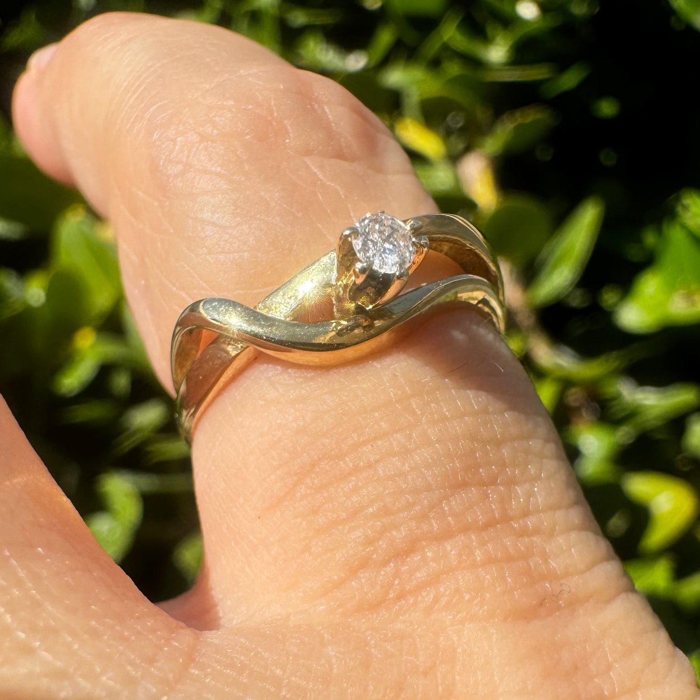 14K gold ring set with a single brilliant-cut diamond