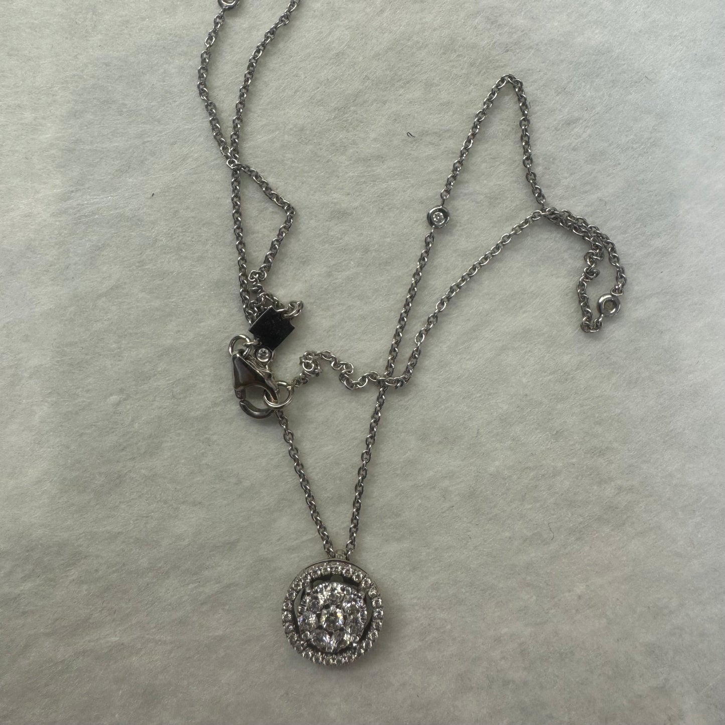 14K gold necklace featuring a round pendant set with a cluster of sparkling Diamonds