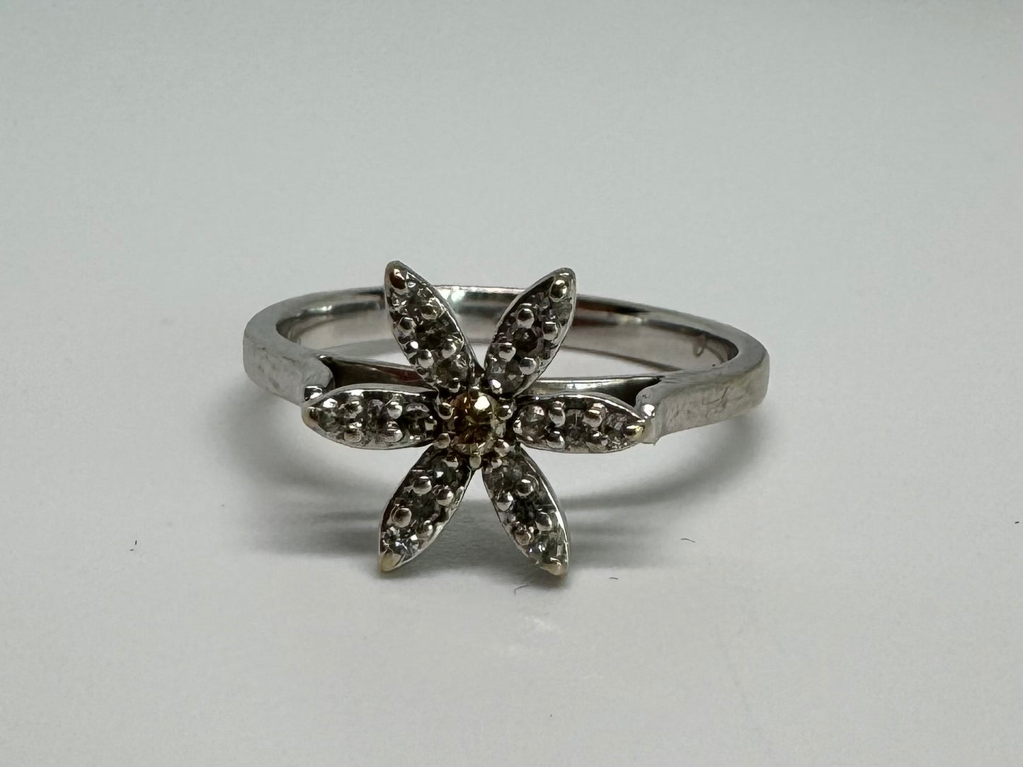 14K gold ring set with a floral design with six petal-shaped segments, each pavé-set with shimmering Diamonds