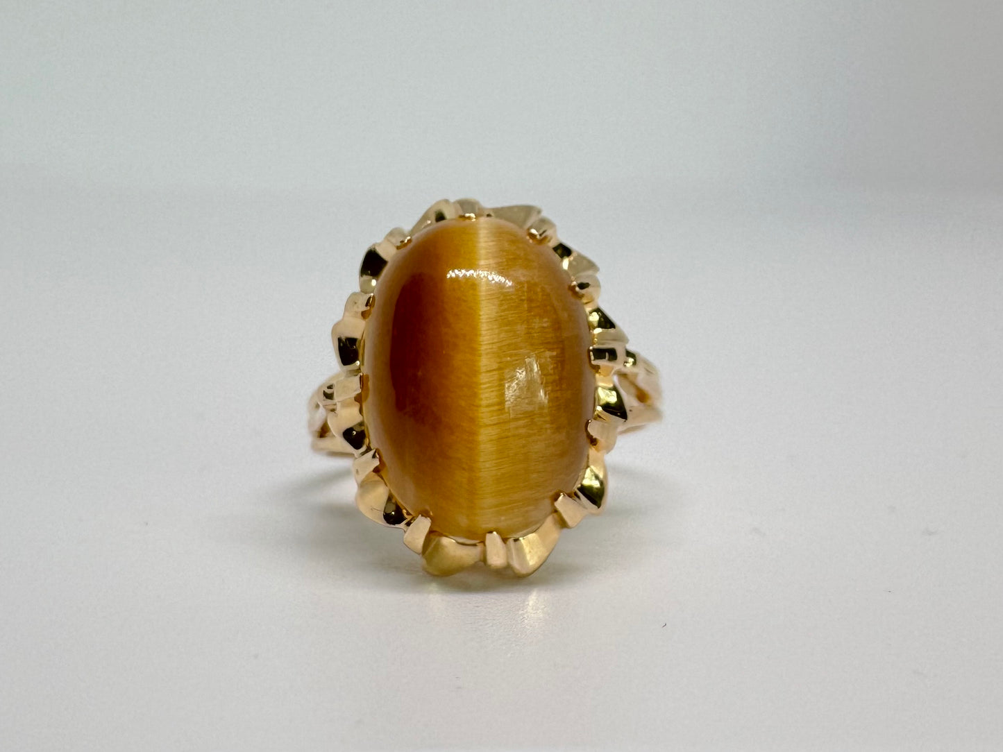 14K gold ring set with a yellow Tiger’s Eye cabochon