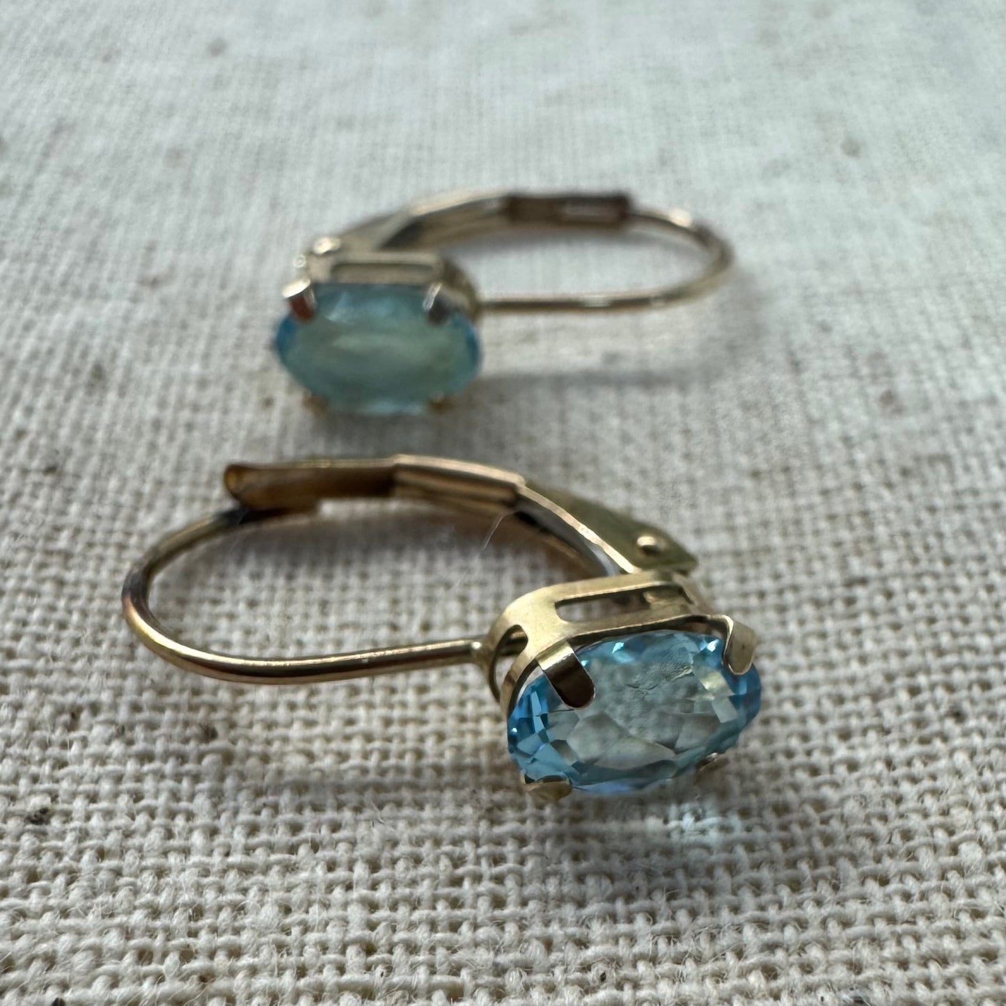 10K gold drop earrings set with sparkling blue topaz