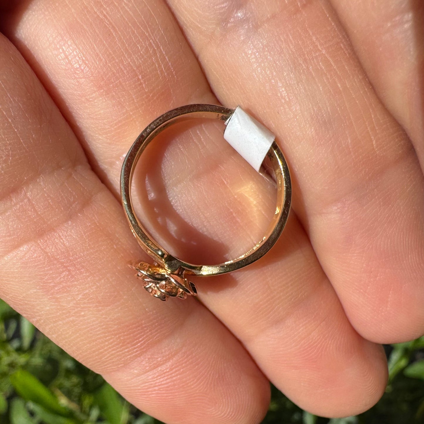 10K two tone gold with a sculpted rose at its center