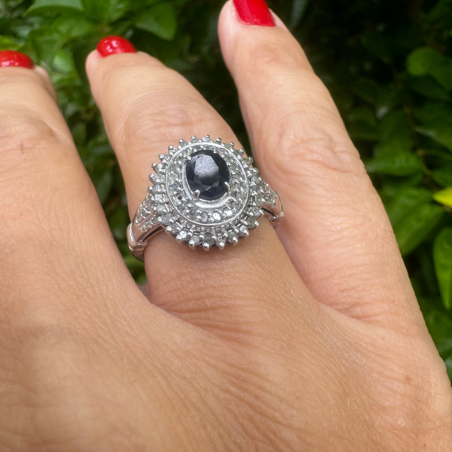 14K gold ring set with an oval-cut Sapphire, surrounded by a stunning double halo of brilliant round Diamonds