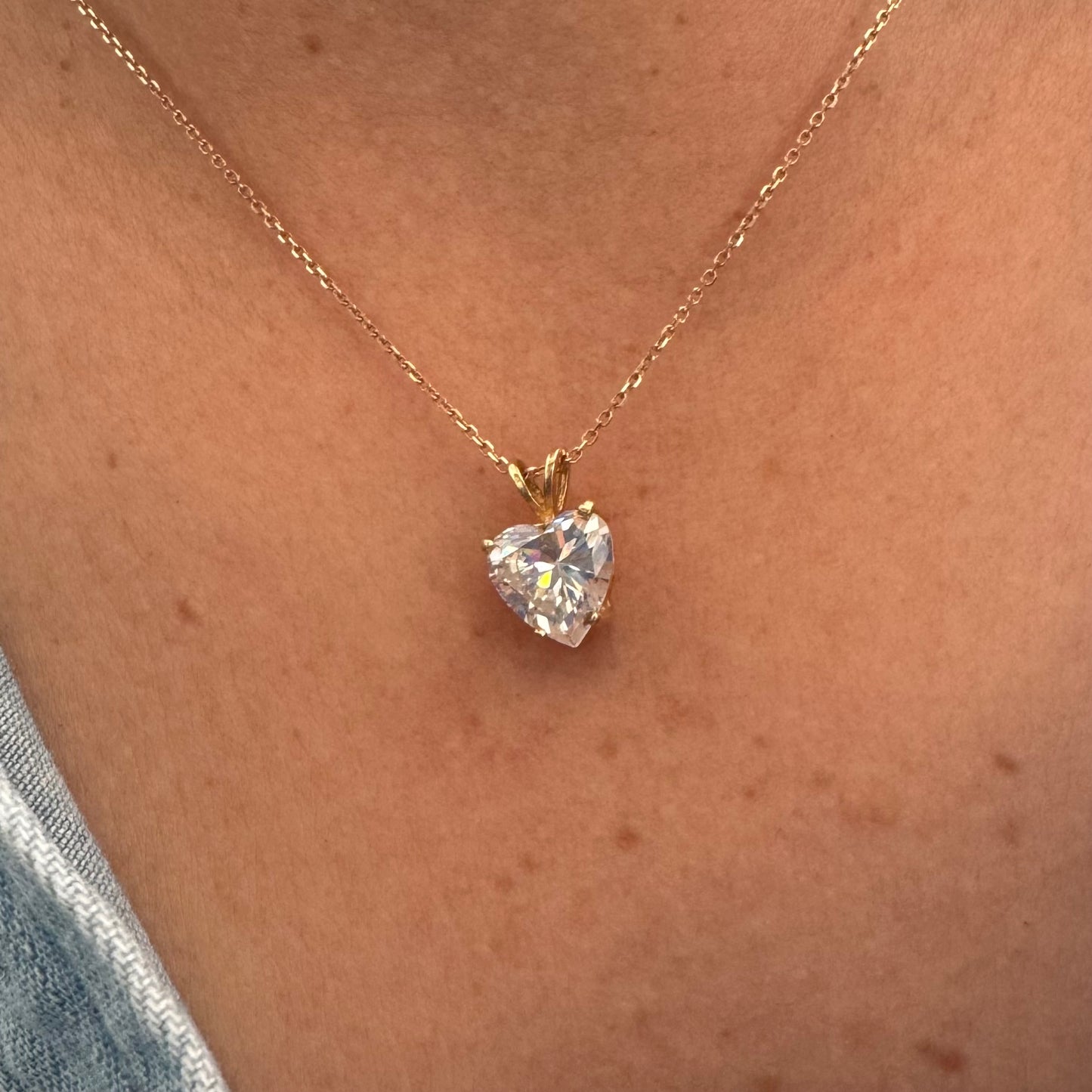 14K gold Heart Pendant set with a brilliant heart-cut clear stone.