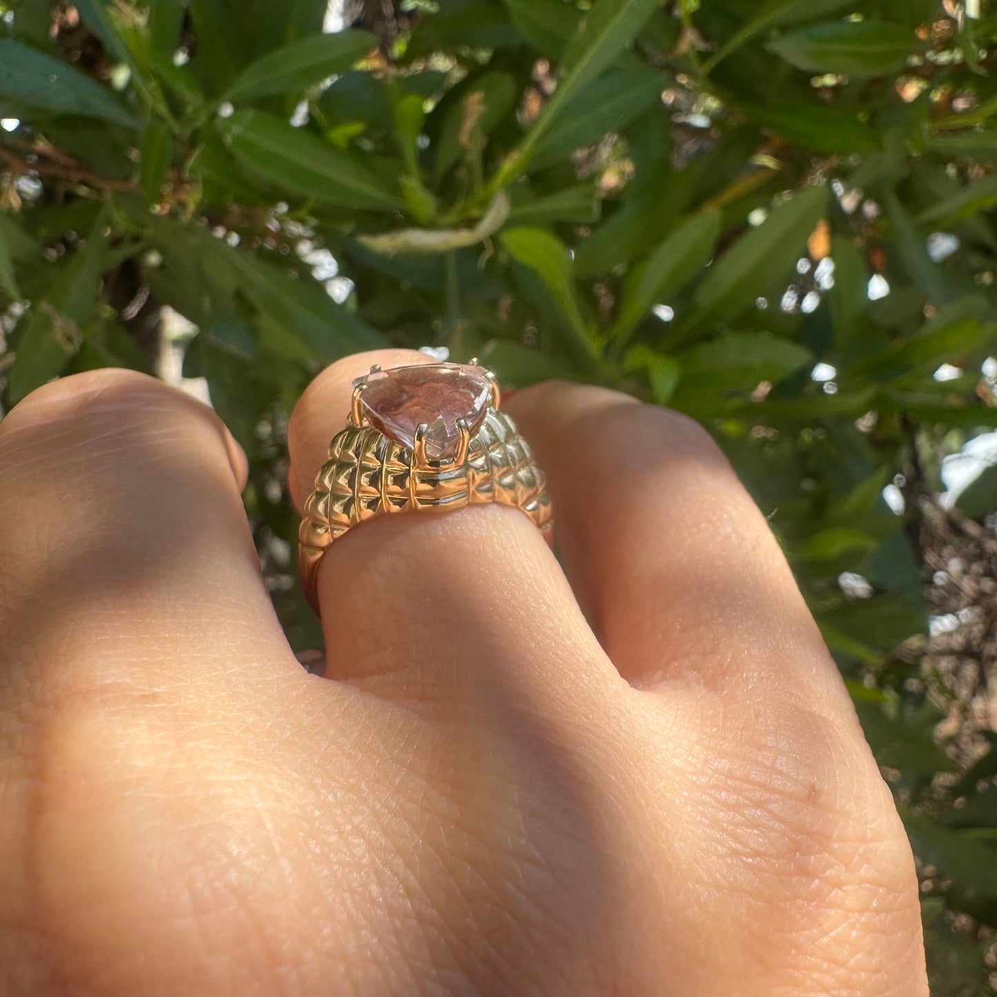 10K gold ring featuring a large, triangular-cut transparent gemstone set in a bold textured band
