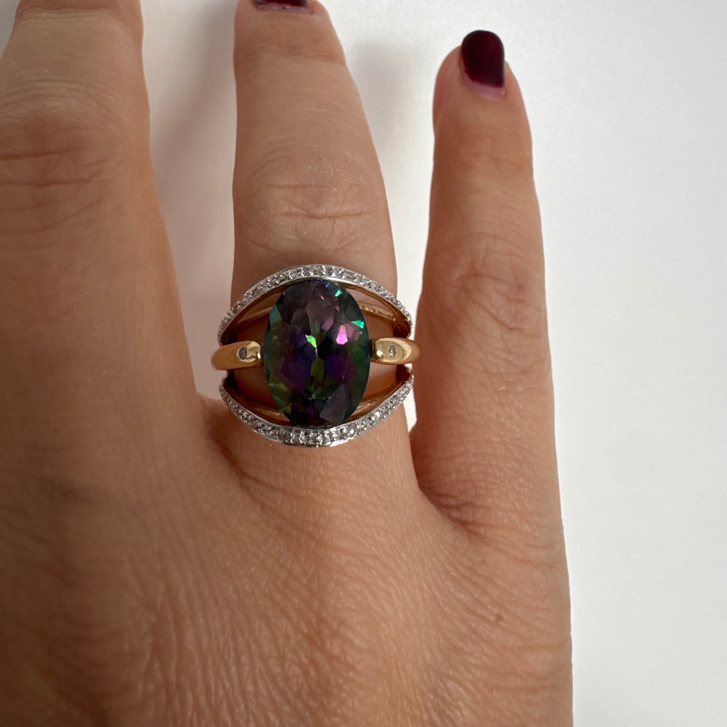 14K gold ring set with an oval Mystic Topaz