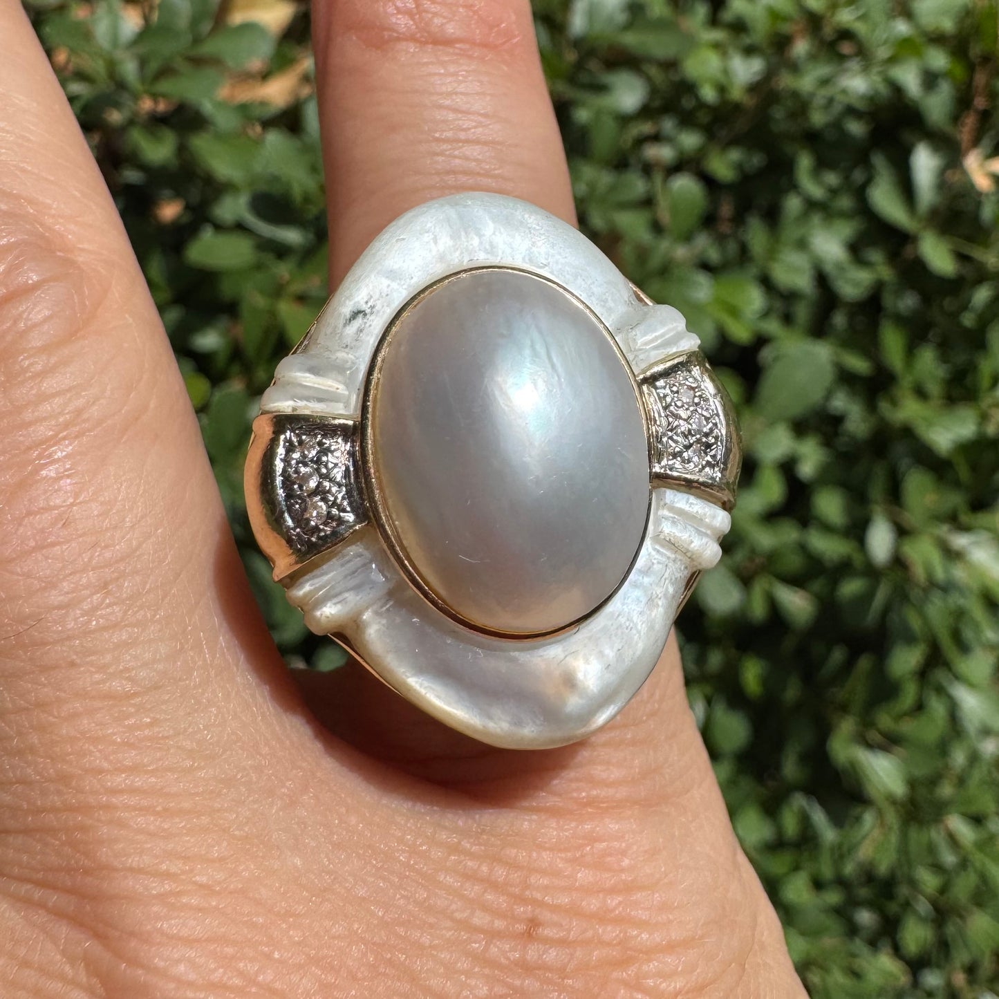 14K gold ring set with a natural mother-of-pearl centerpiece framed by delicate diamond accents