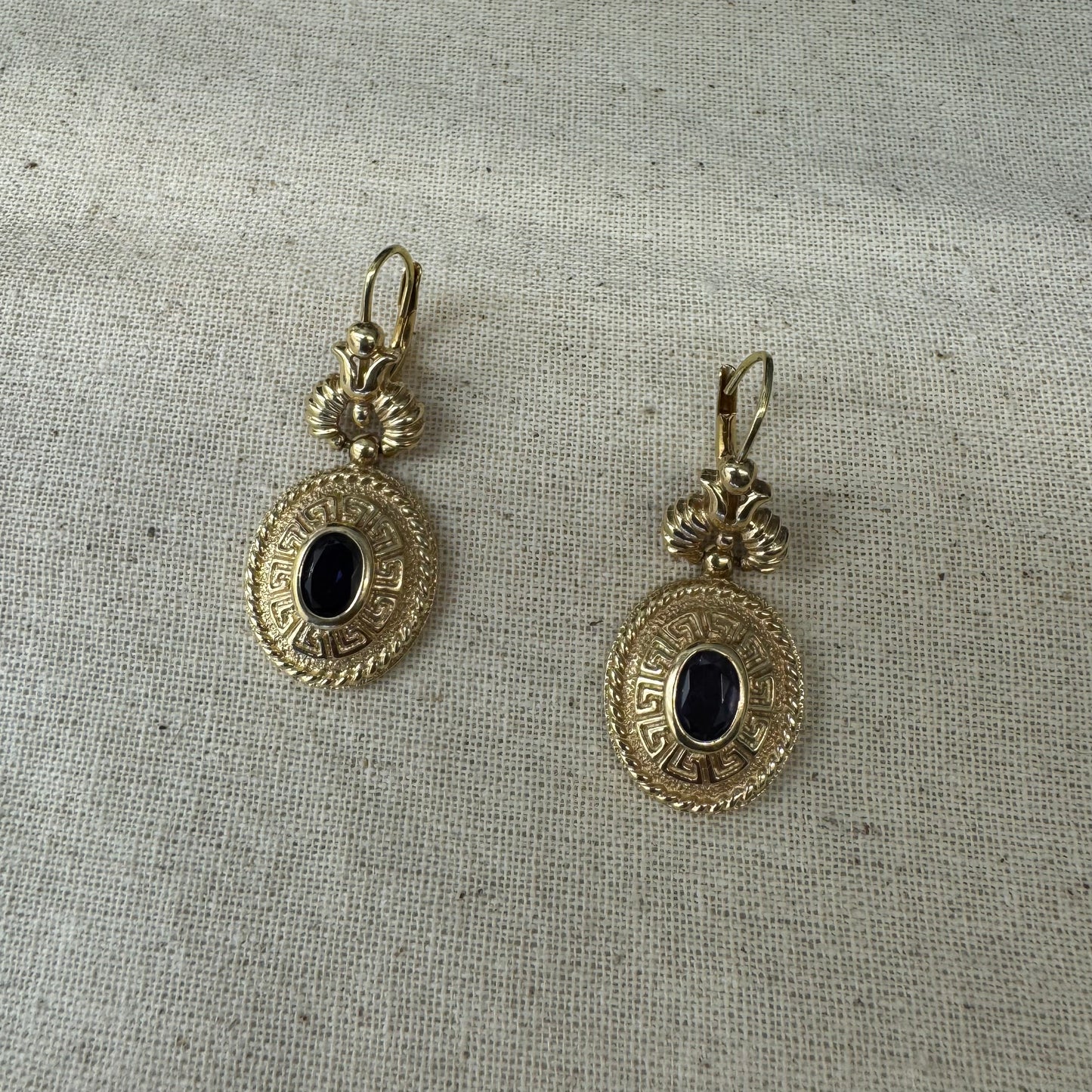 14K gold drop earrings set with Tanzanite in ornate medallion