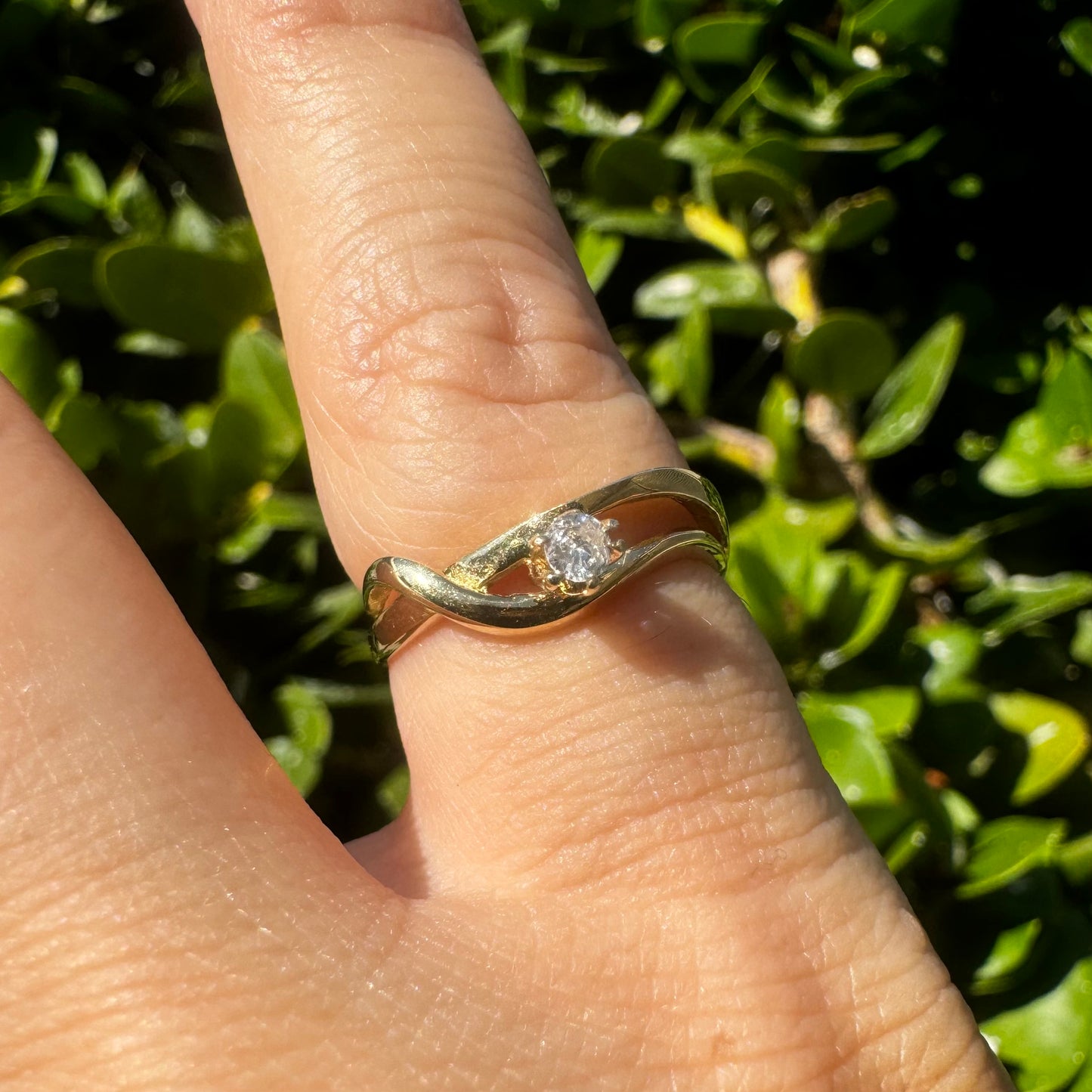 14K gold ring set with a single brilliant-cut diamond