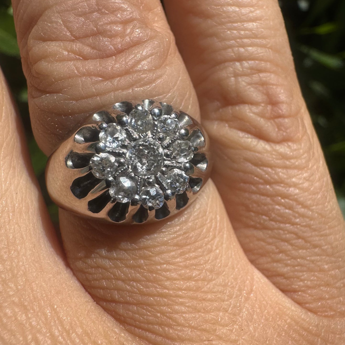14K gold ring set with a cluster of old cut diamonds arranged in a floral design