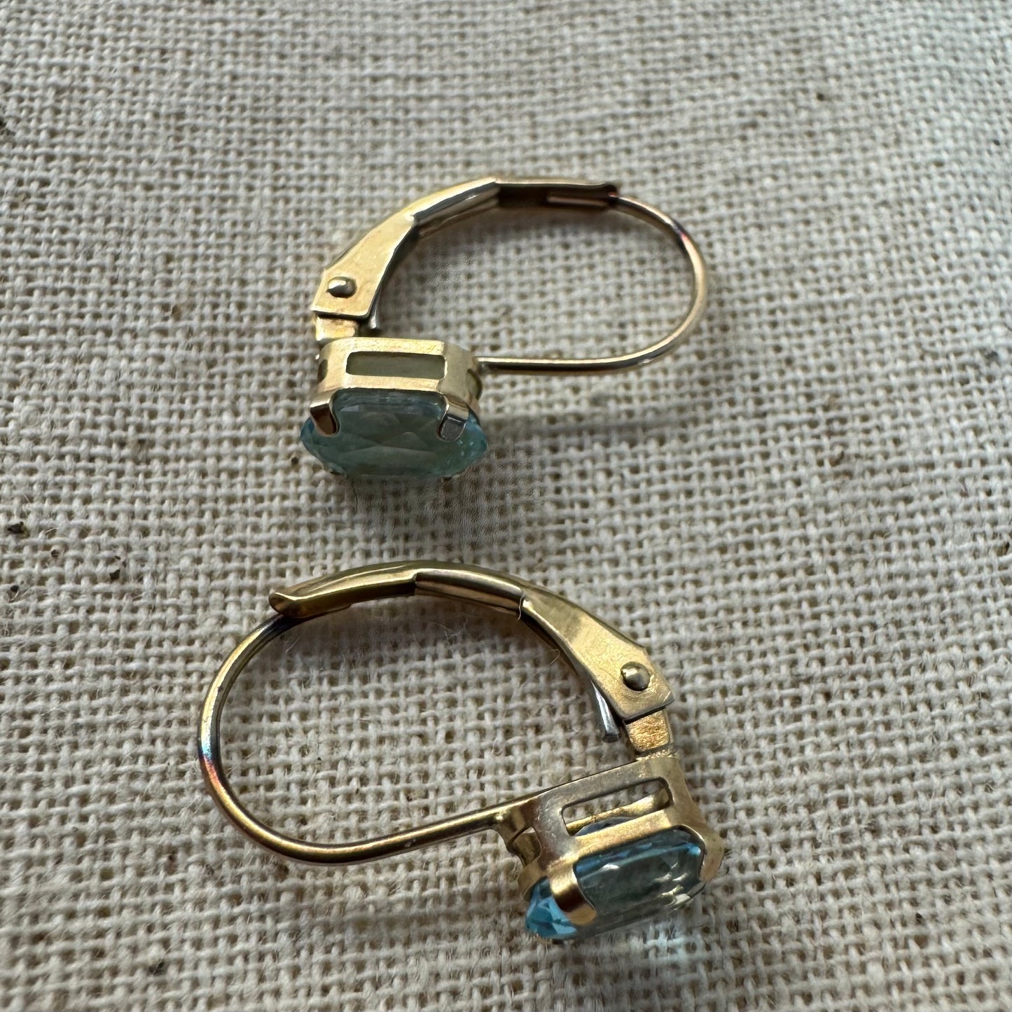 10K gold drop earrings set with sparkling blue topaz