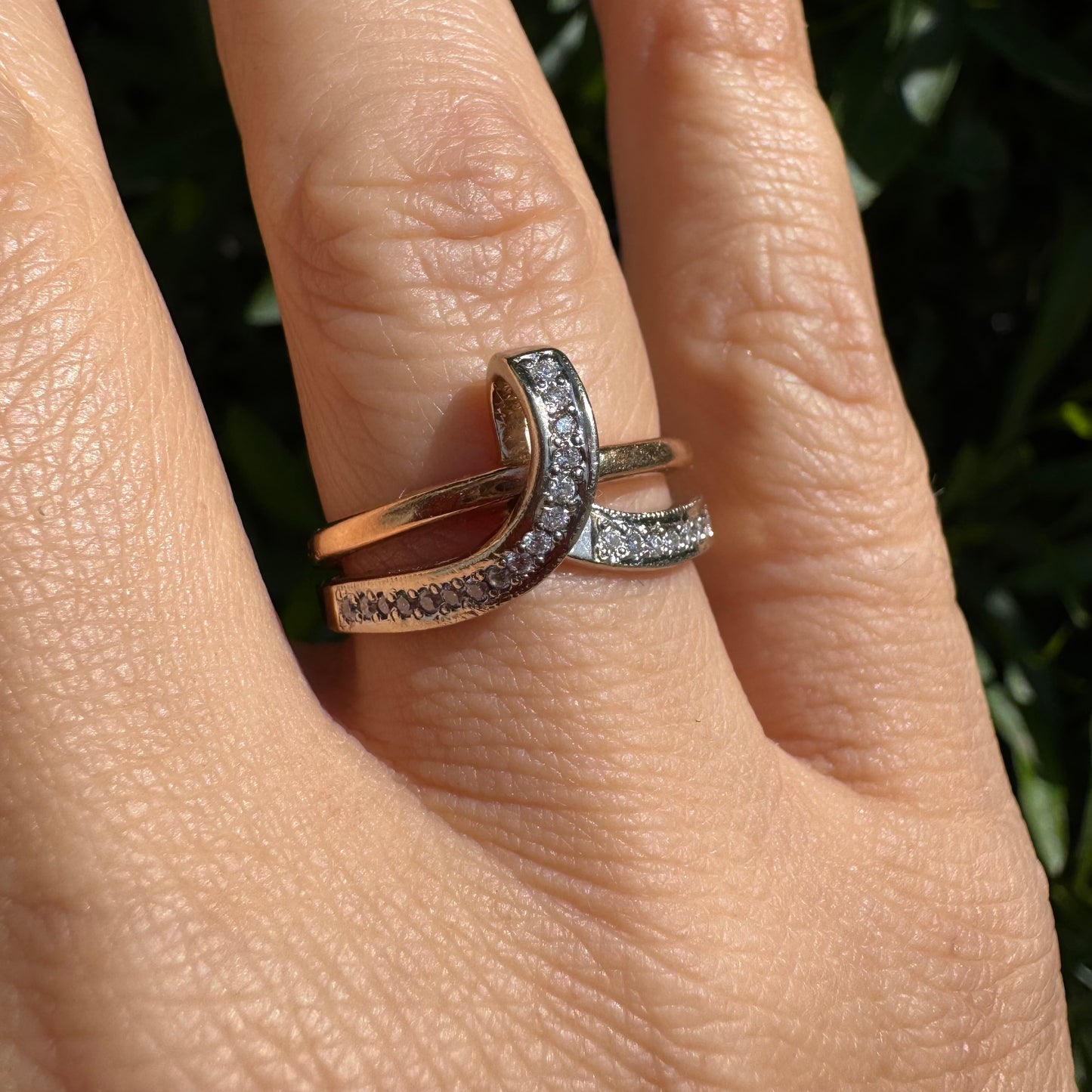 18K two-tone gold (rose & white) crossover ring featuring a row of sparkling Diamonds along each band, creating an elegant and modern design.