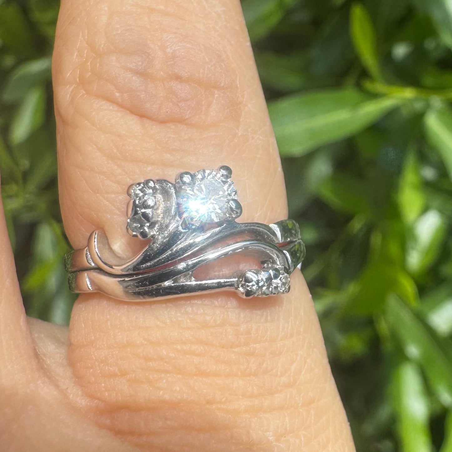 14K gold ring set with round-cut diamonds in a flowing design