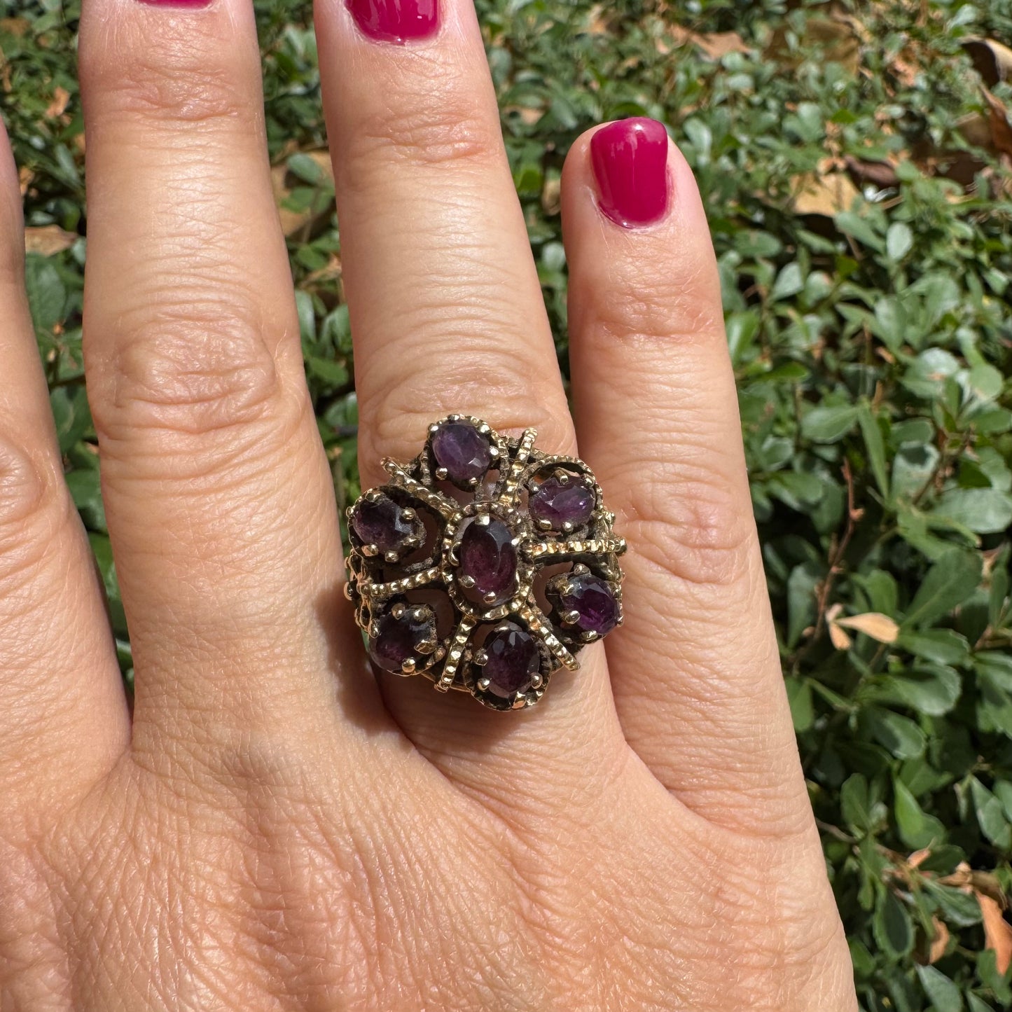 14K gold cocktail ring set with a stunning cluster of deep purple Garnet stones in marquise cuts.