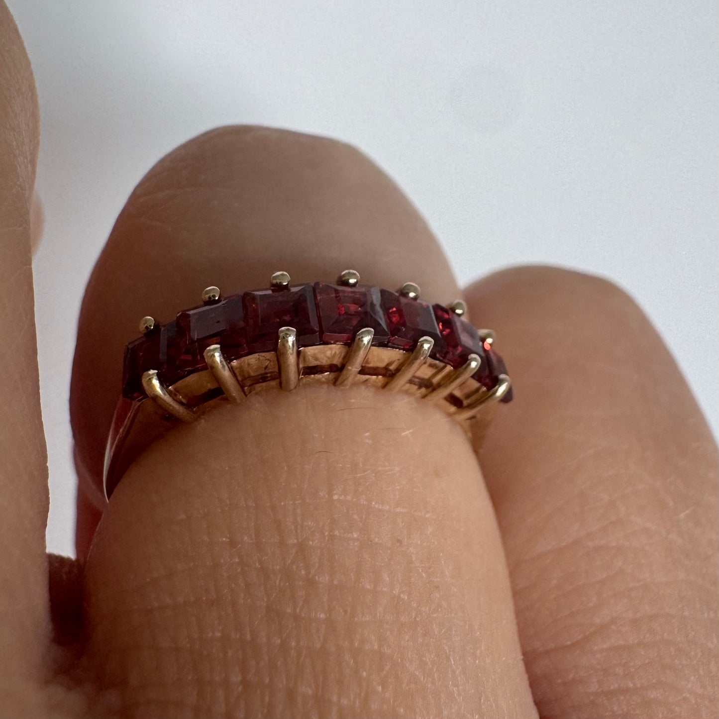 9K gold ring set with deep red garnets