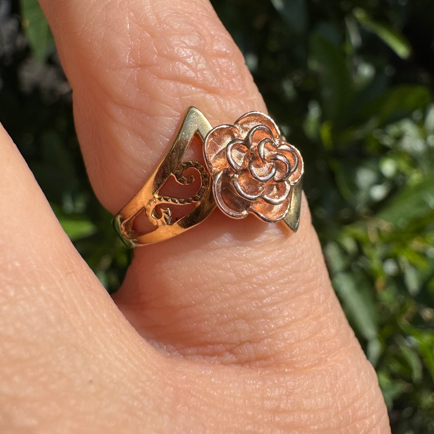 10K two tone gold with a sculpted rose at its center
