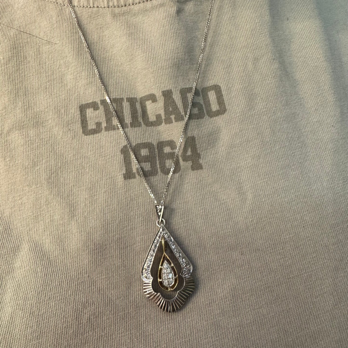 14K white and yellow gold pendant in a unique geometric design set with Diamonds