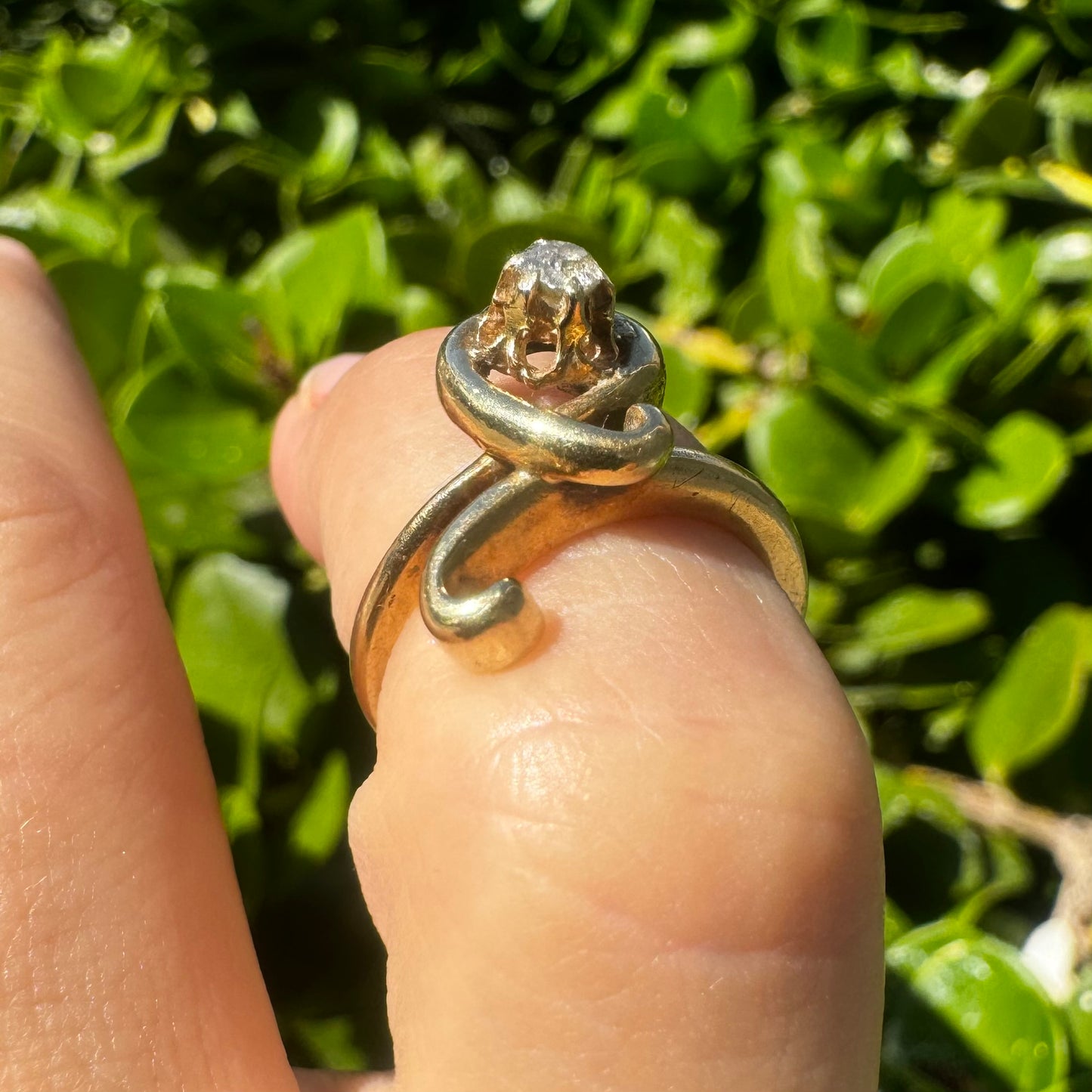 14K gold ring set with a brilliant-cut Diamond, embraced by a flowing, sculptural gold design