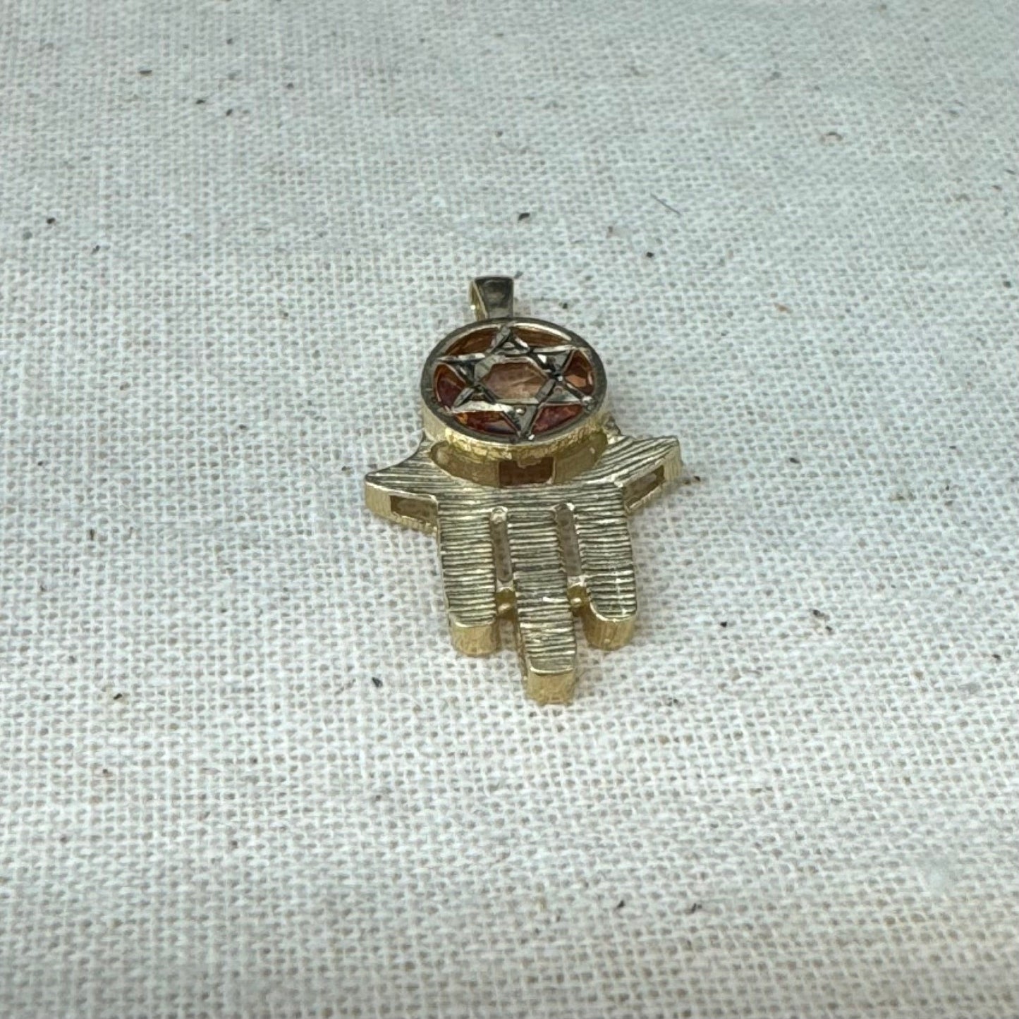 14K gold Hamsa pendant, featuring a deep orange gemstone framed by a Star of David.