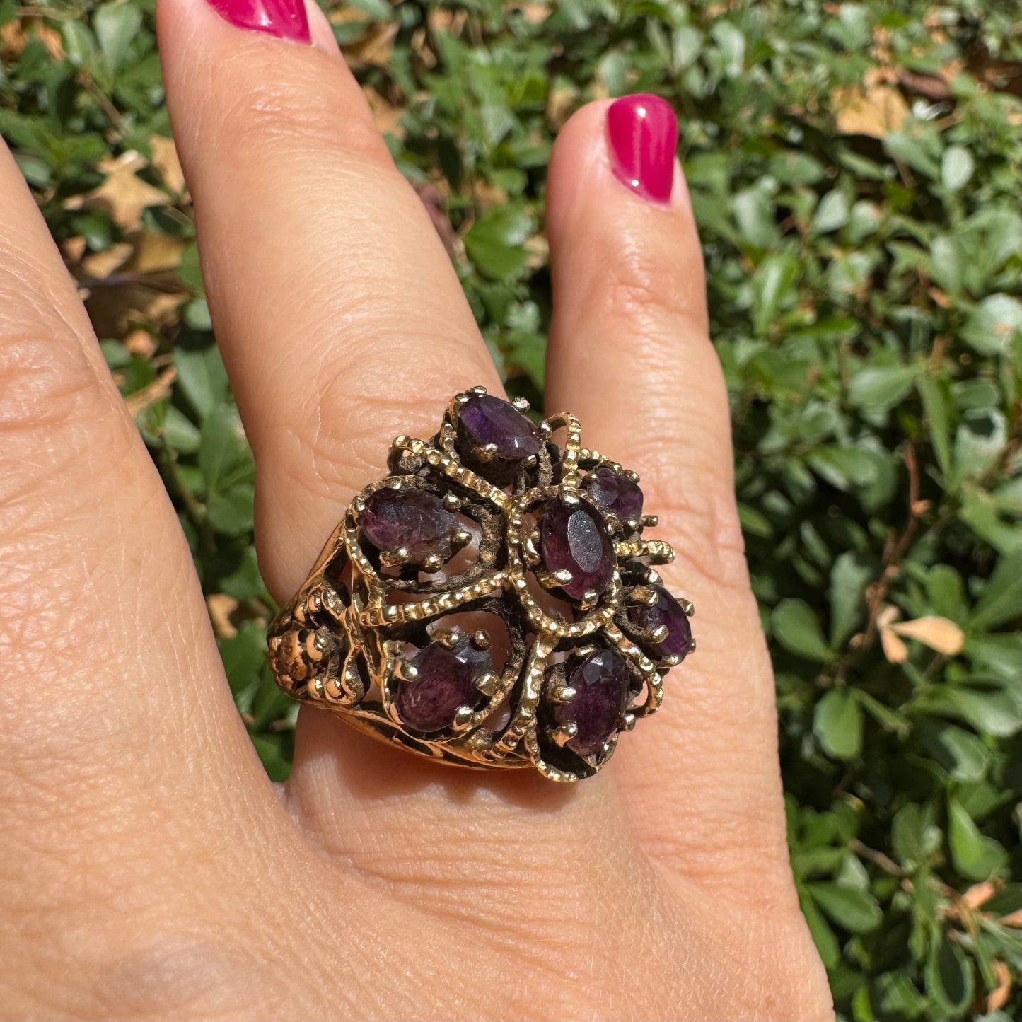 14K gold cocktail ring set with a stunning cluster of deep purple Garnet stones in marquise cuts.