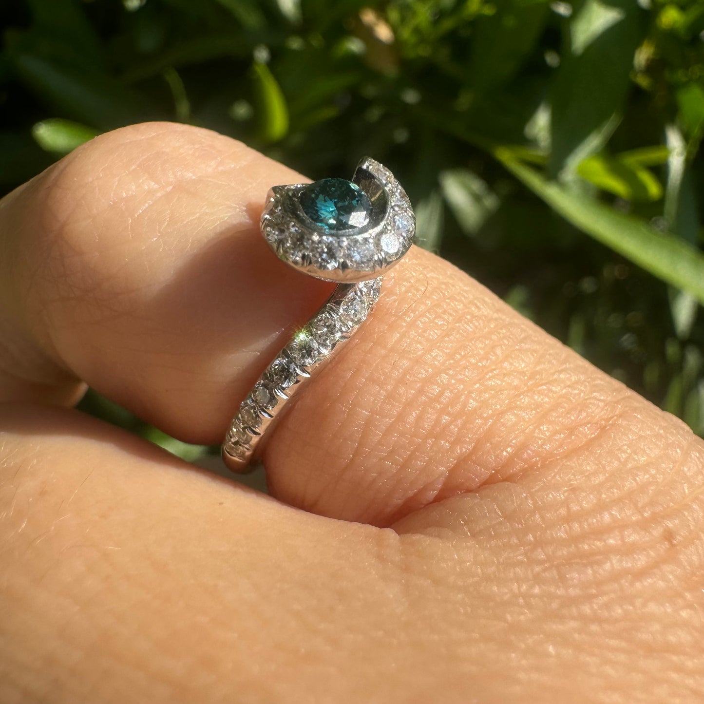 18K gold ring set with a vivid blue Diamond at its heart, embraced by a shimmering halo of white diamonds and a bold open design