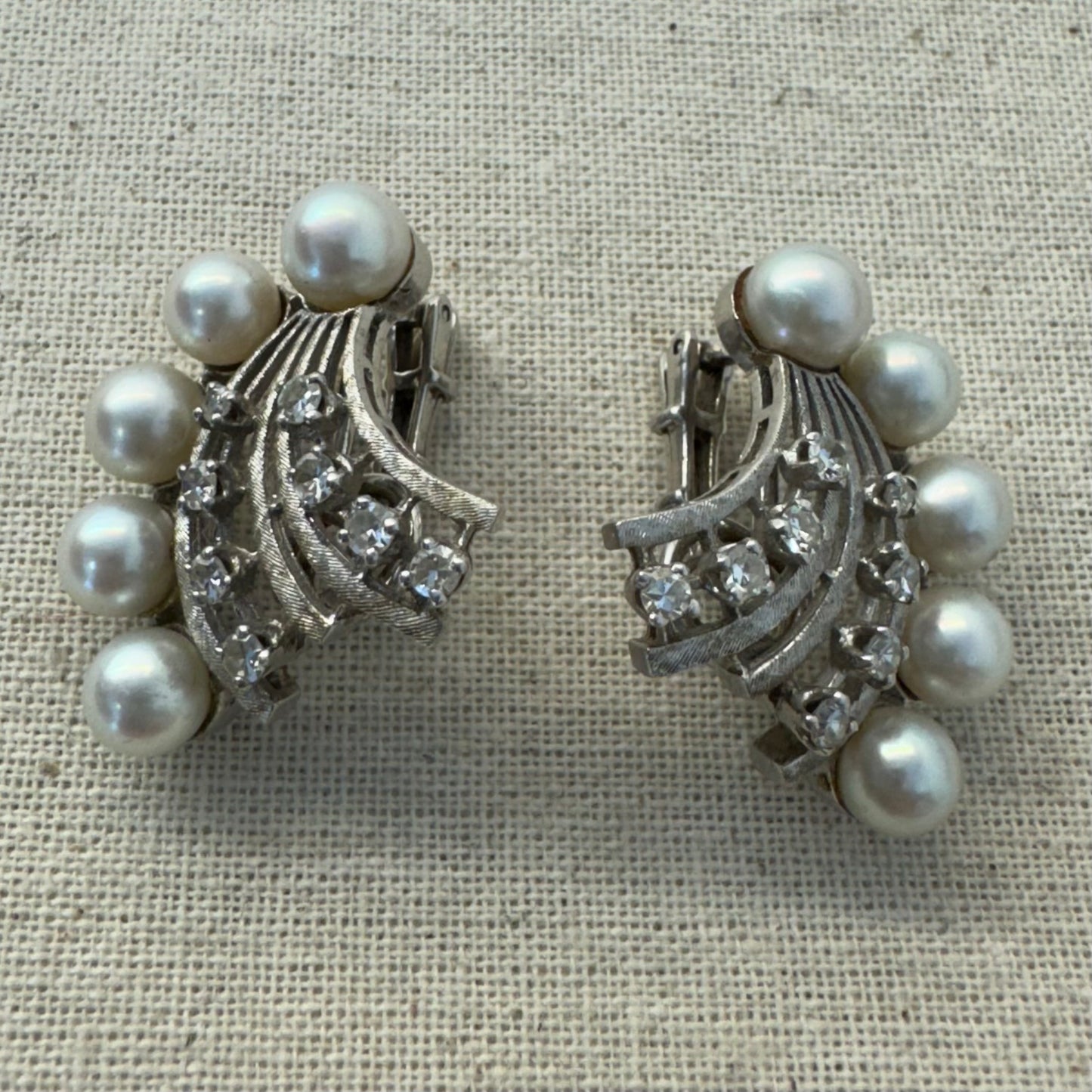 14K gold clip-on earrings inspired by 1950s Hollywood style, set with a row of luminous round pearls & Diamonds