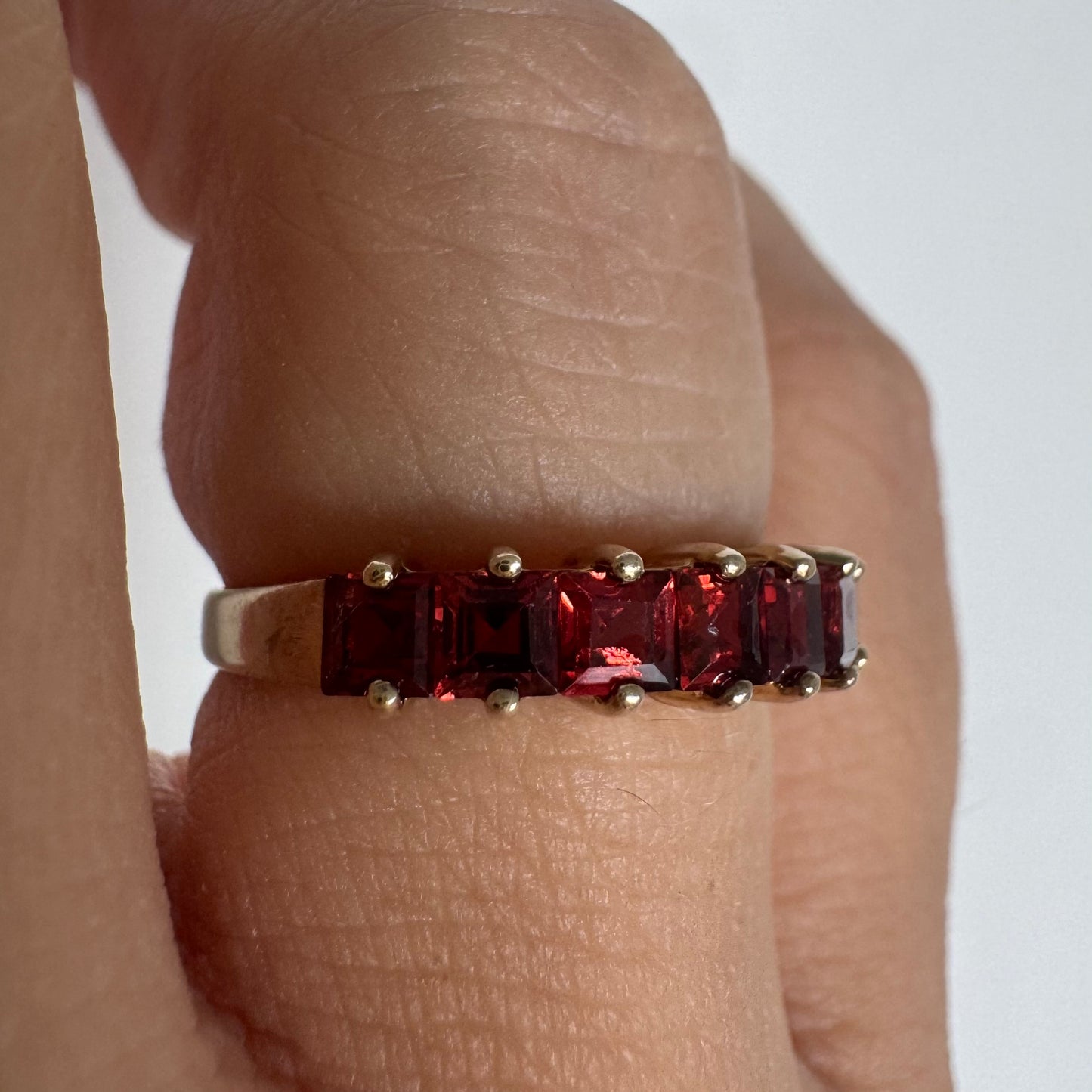 9K gold ring set with deep red garnets