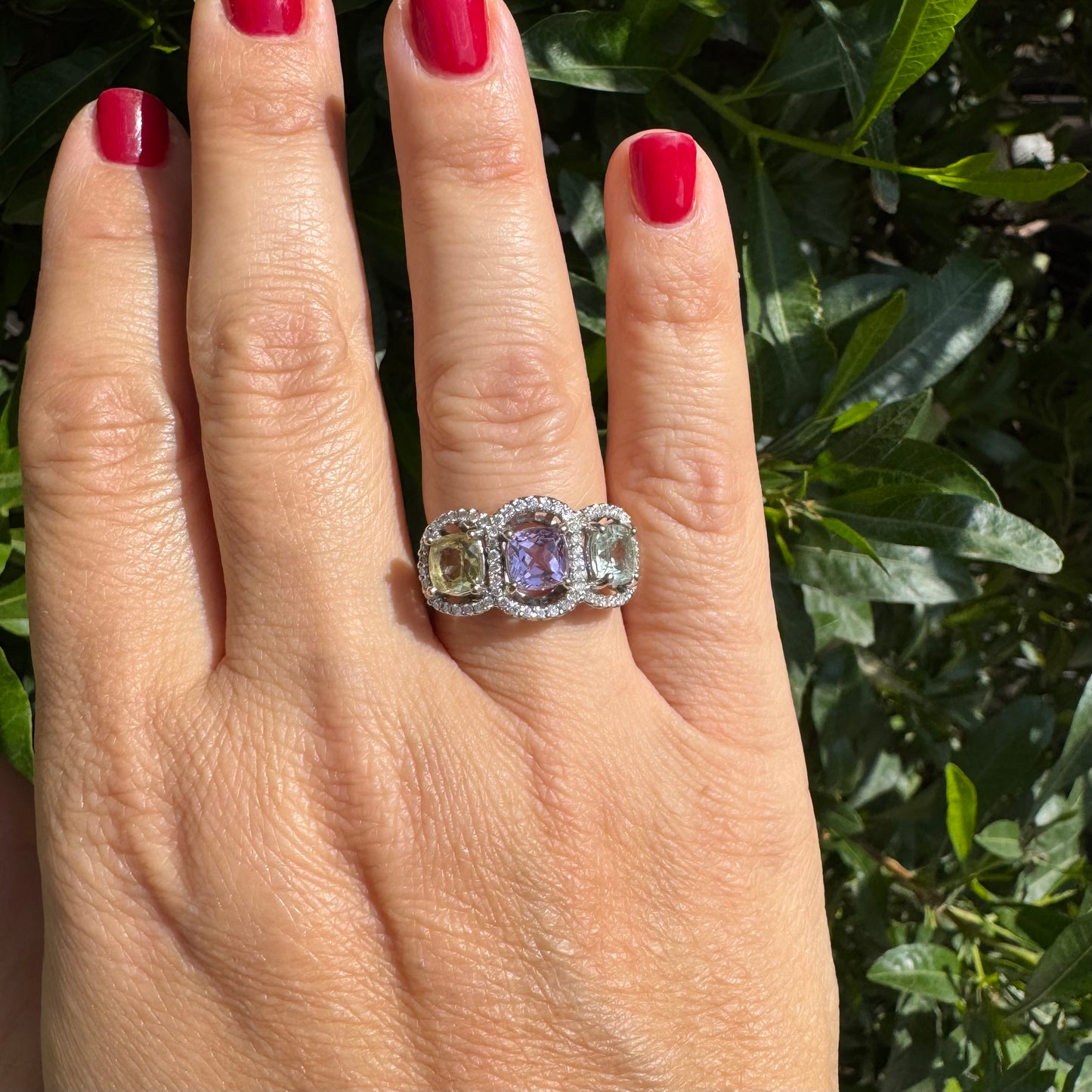 18K gold ring set with three pastel gemstones in soft shades of lilac, yellow and light gray