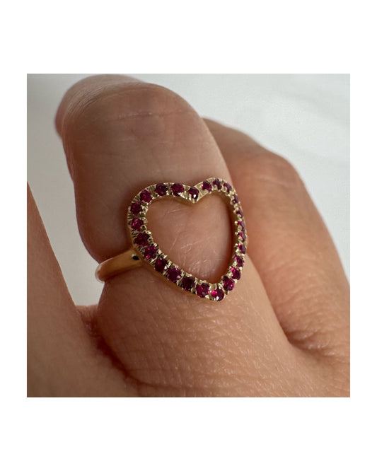 14K yellow gold open-heart ring set with deep red rubies along the frame.