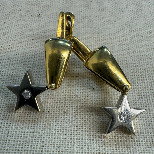 18K gold earrings set with a sparkling Diamond at the center.