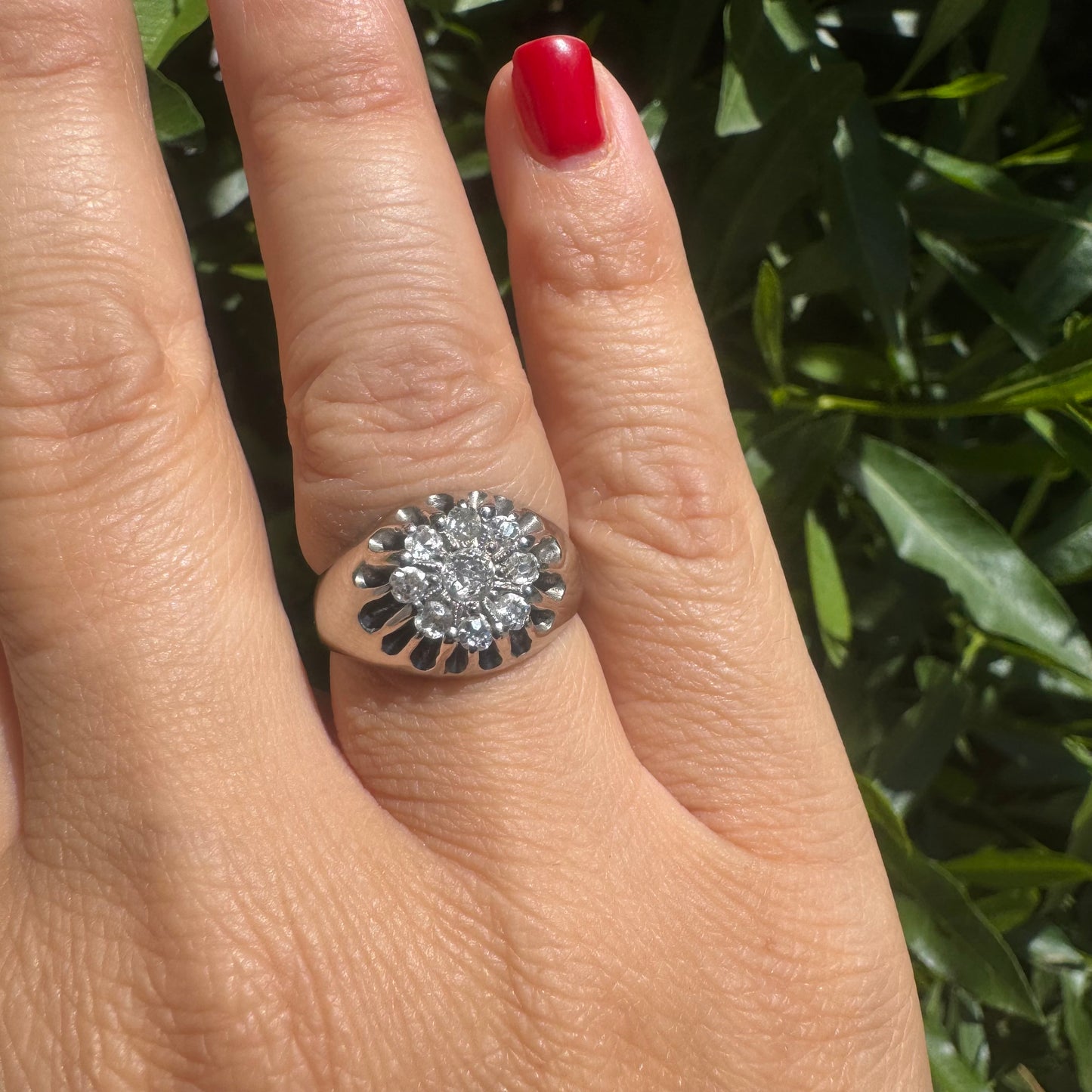 14K gold ring set with a cluster of old cut diamonds arranged in a floral design