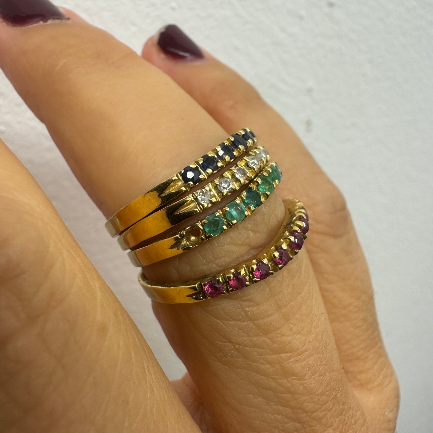 18K yellow gold ring set with vibrant rows of Sapphires, Emeralds, Rubies, and Diamonds