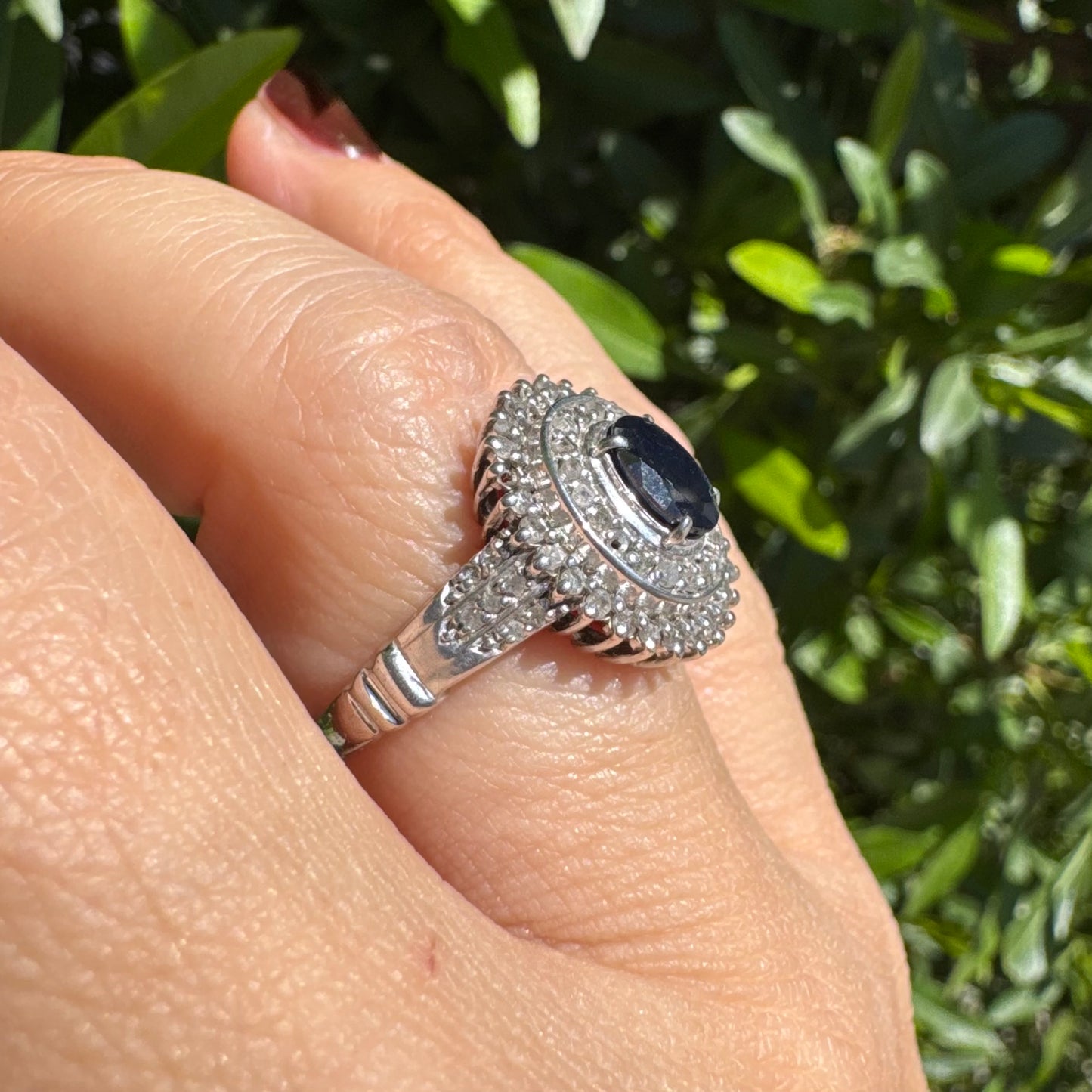 14K gold ring set with an oval-cut Sapphire, surrounded by a stunning double halo of brilliant round Diamonds