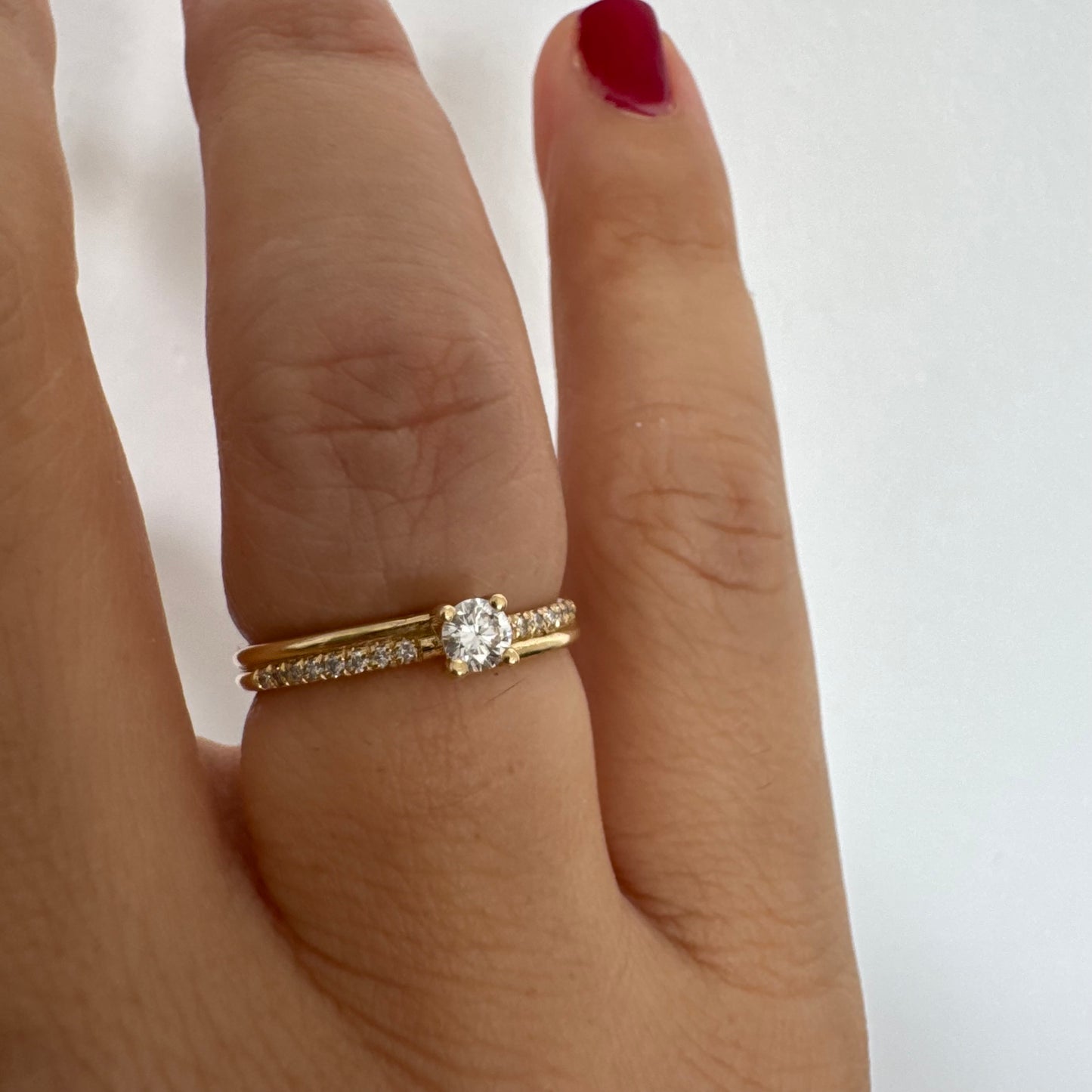 טבעת זהב צהוב 14 קראט משובצת יהלום מרכזי בחיתוך עגול ופס יהלומים עדין.