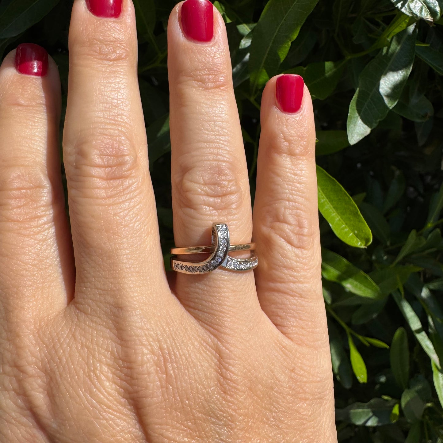 18K two-tone gold (rose & white) crossover ring featuring a row of sparkling Diamonds along each band, creating an elegant and modern design.