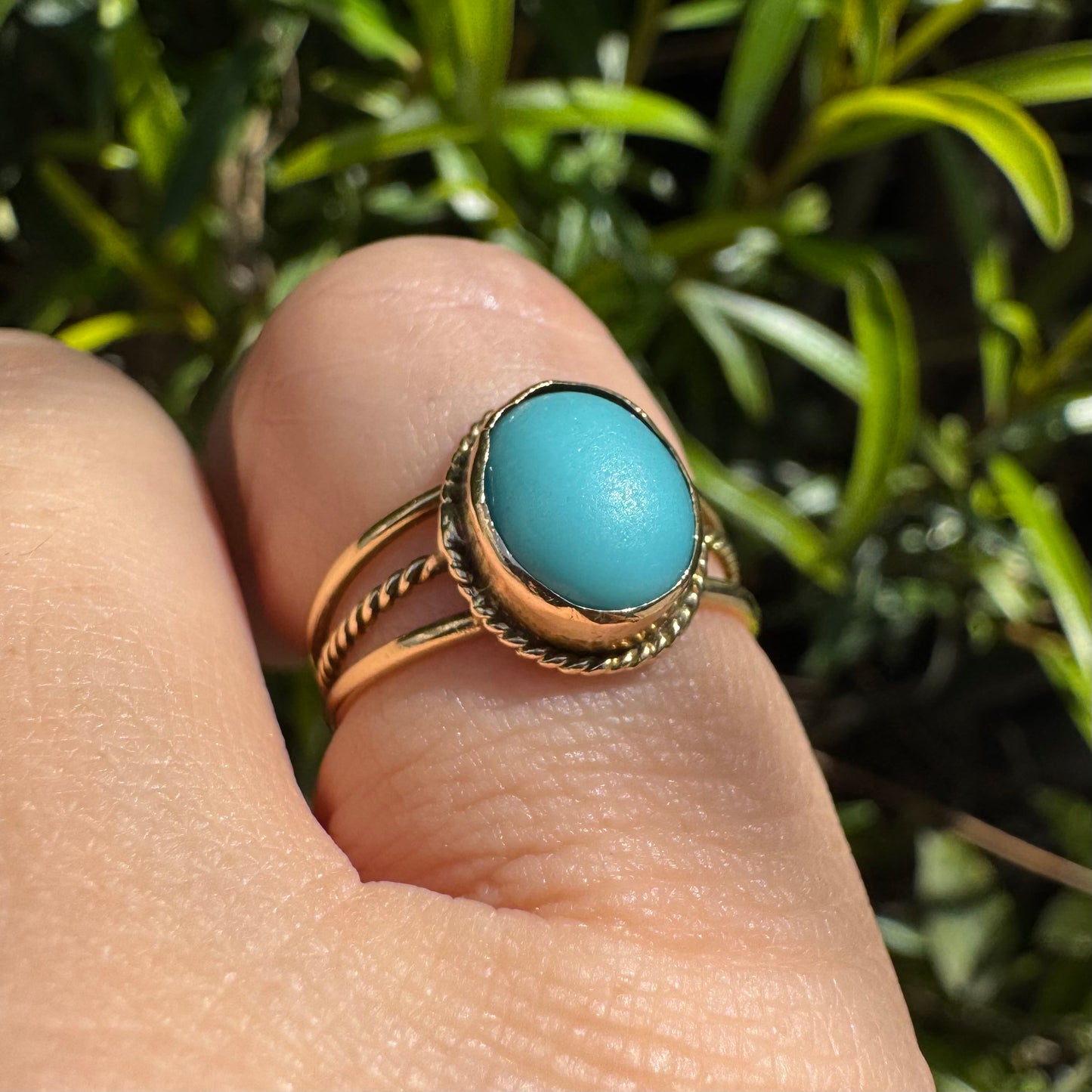 14K gold ring set with an oval Turquoise stone in a delicate rope-style bezel