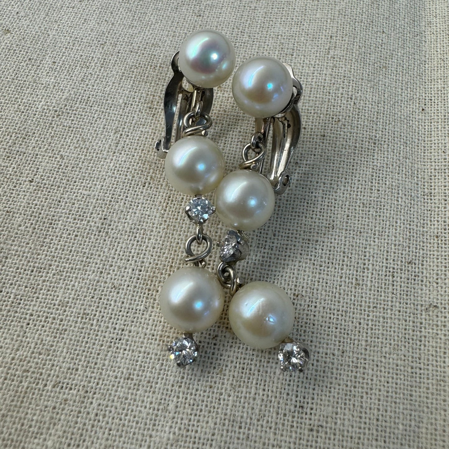 14K gold elegant drop earring set with three soft creamy Pearls connected by round brilliant Diamonds
