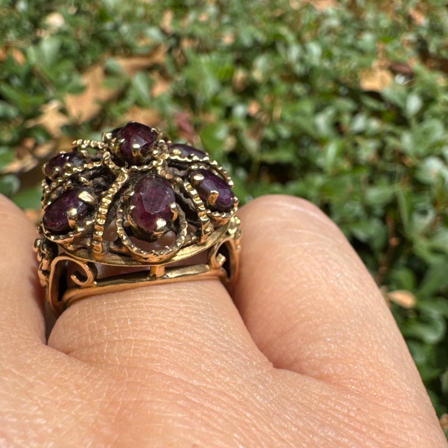 14K gold cocktail ring set with a stunning cluster of deep purple Garnet stones in marquise cuts.