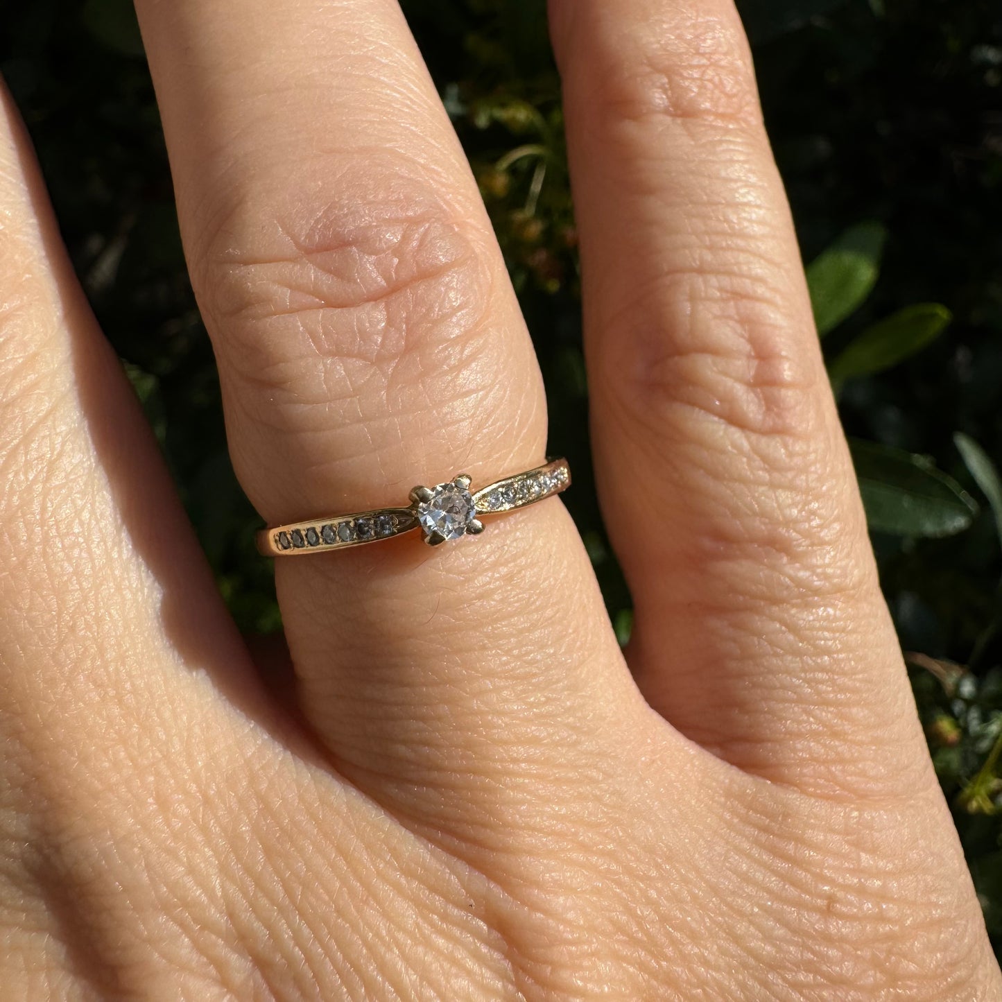 14K gold ring set with one center Diamond and side Diamonds