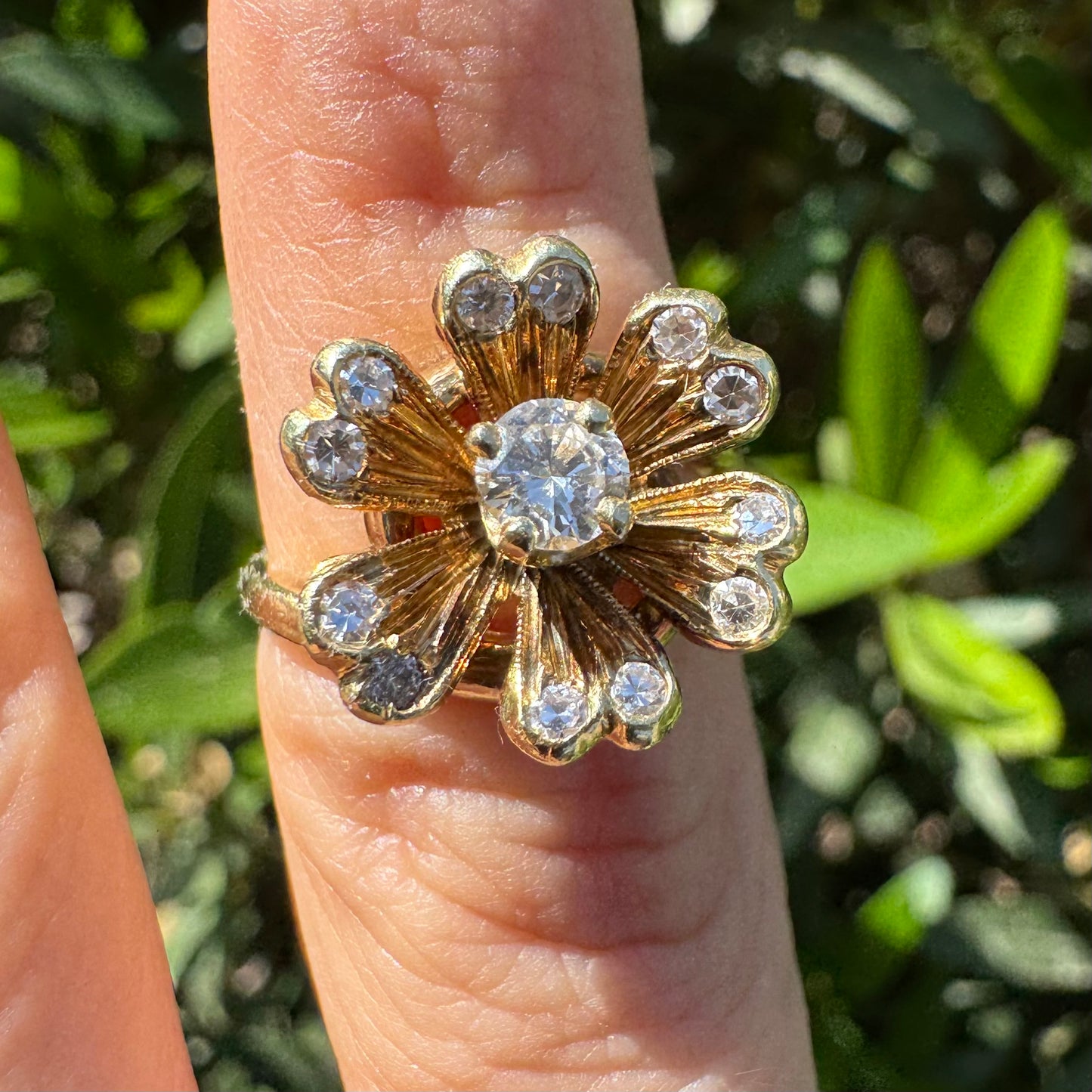 14K gold ring in a floral design, set with sparkling Diamonds at the center and around the petals.