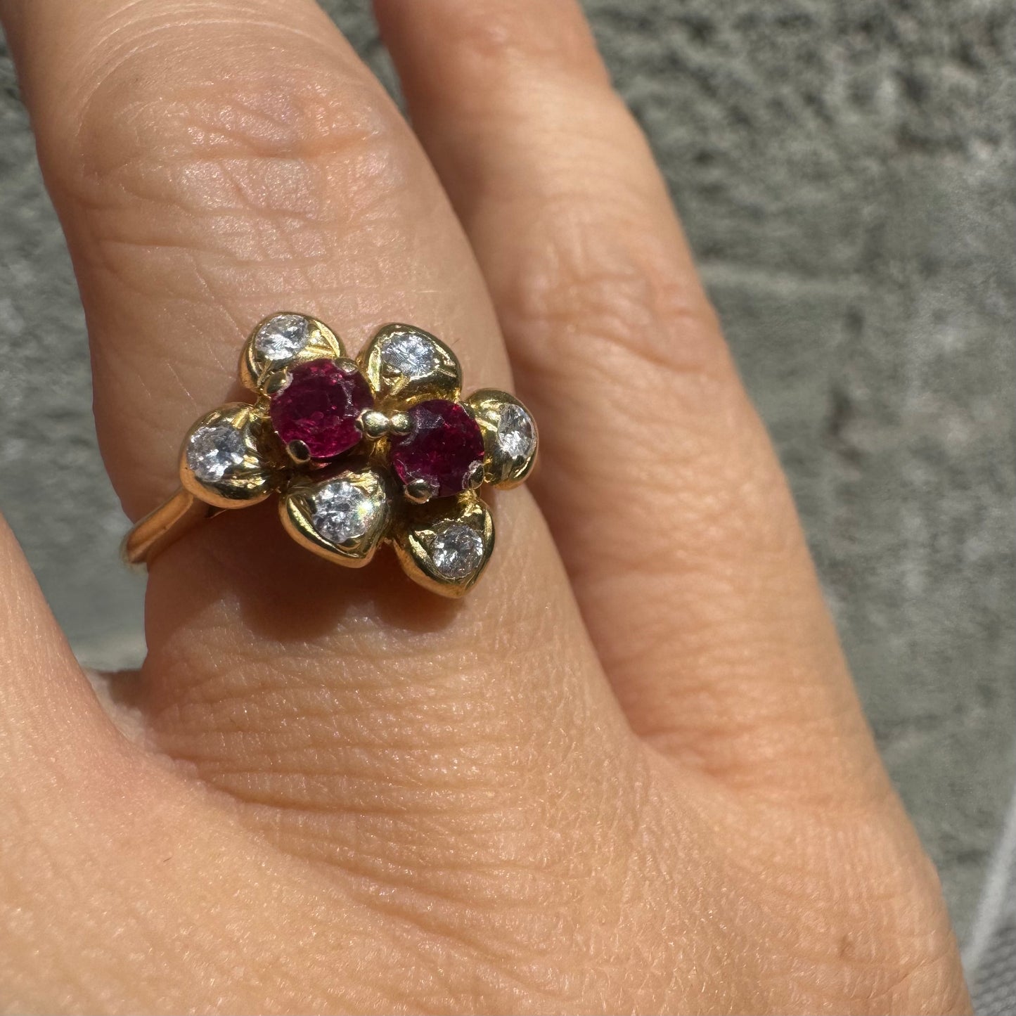 18K gold ring designed like a flower, set with two deep red Rubies and sparkling Diamonds