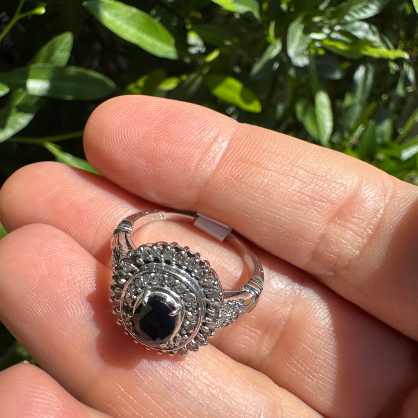 14K gold ring set with an oval-cut Sapphire, surrounded by a stunning double halo of brilliant round Diamonds
