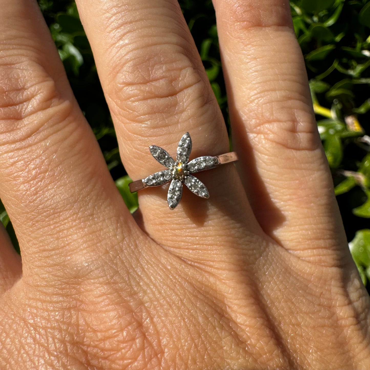 14K gold ring set with a floral design with six petal-shaped segments, each pavé-set with shimmering Diamonds