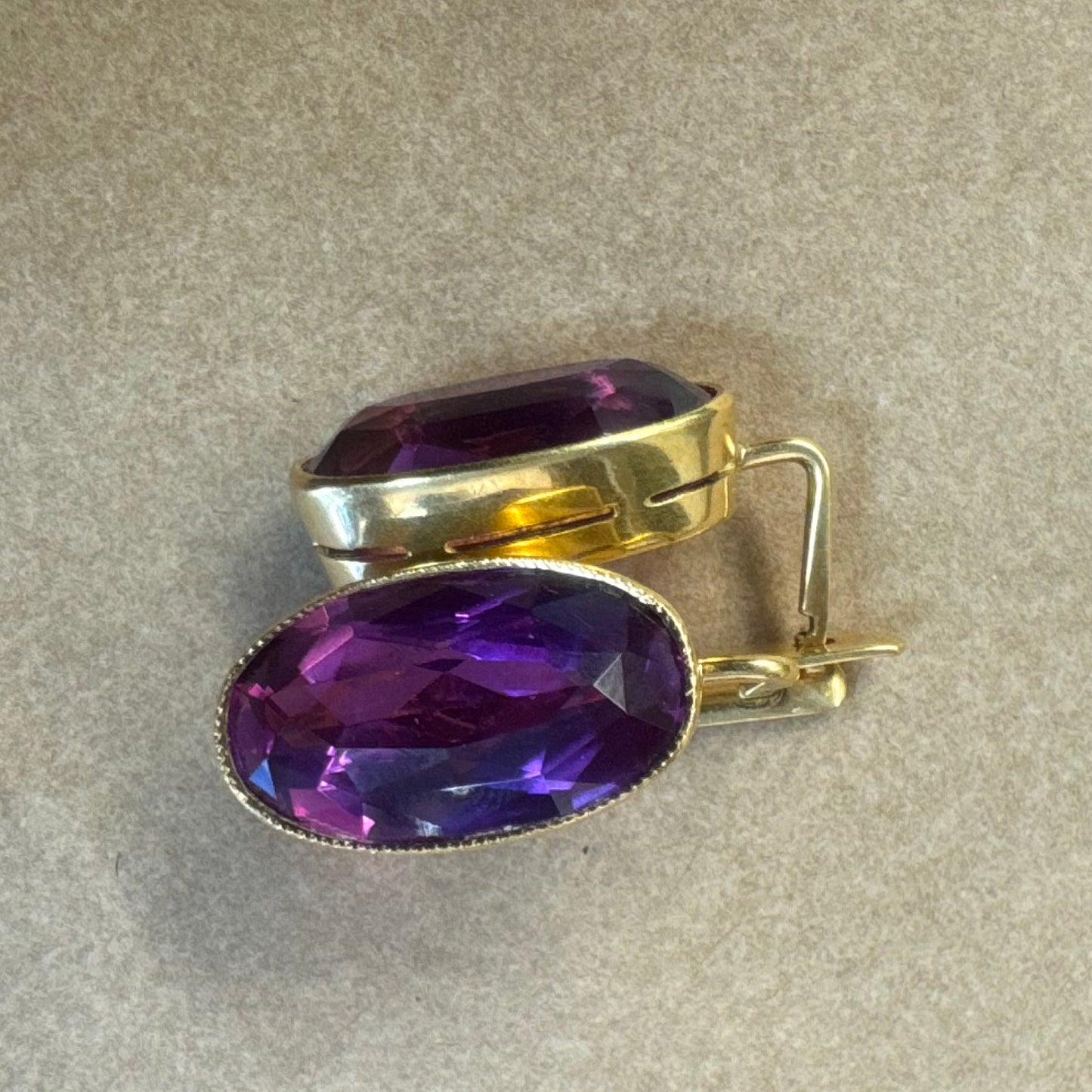 עגילי זהב צהוב 18 קראט, תלויים קצרים, משובצים באבני אמטיסט סגולות בחיתוך אובלי עמוק.