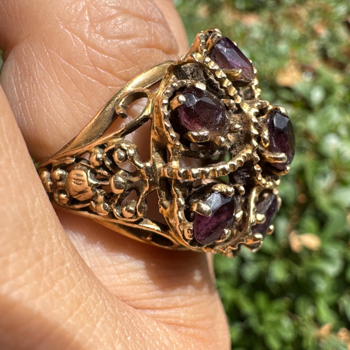 14K gold cocktail ring set with a stunning cluster of deep purple Garnet stones in marquise cuts.