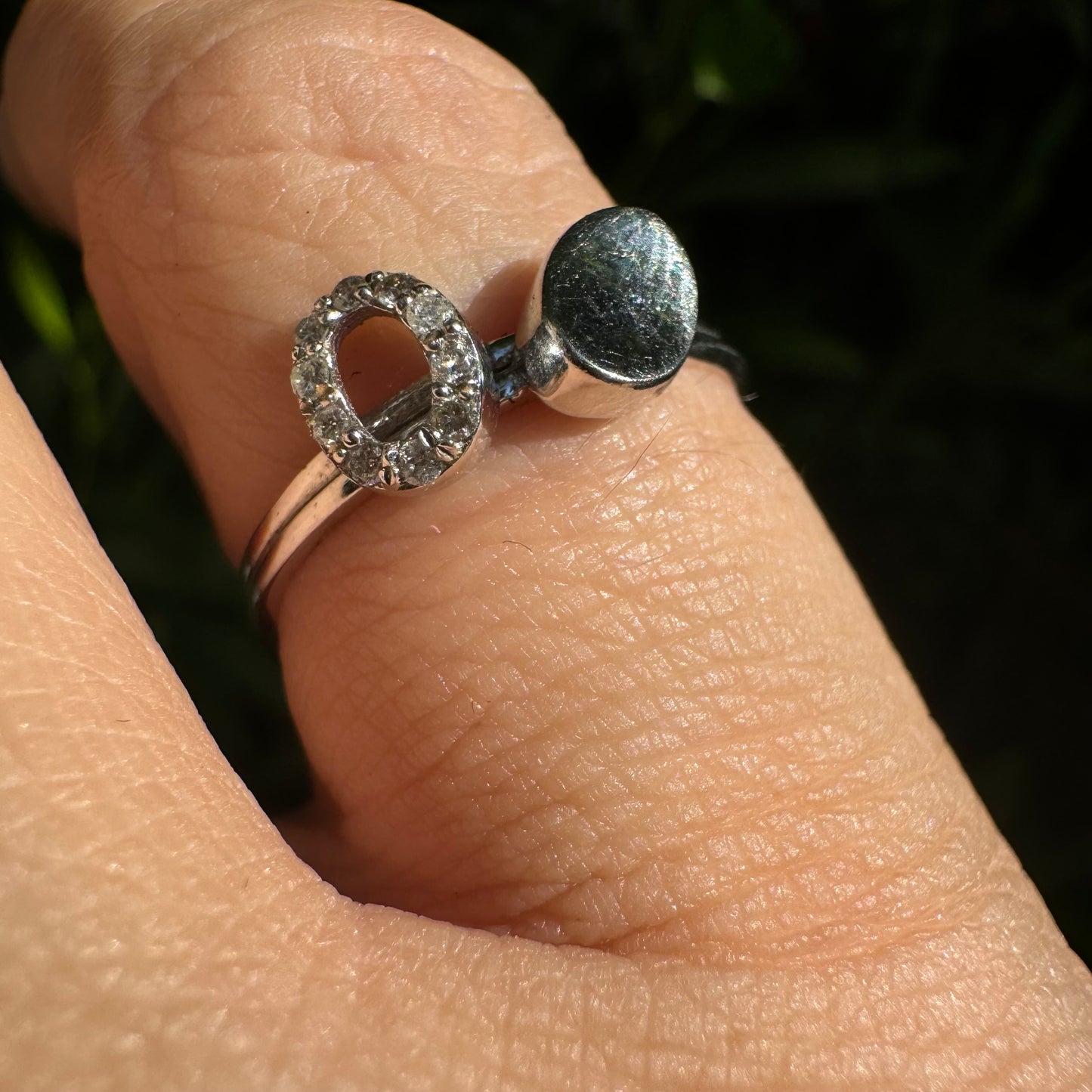 14K gold open ring featuring two ends: one with a sparkling oval of Diamonds and the other with a smooth polished oval.