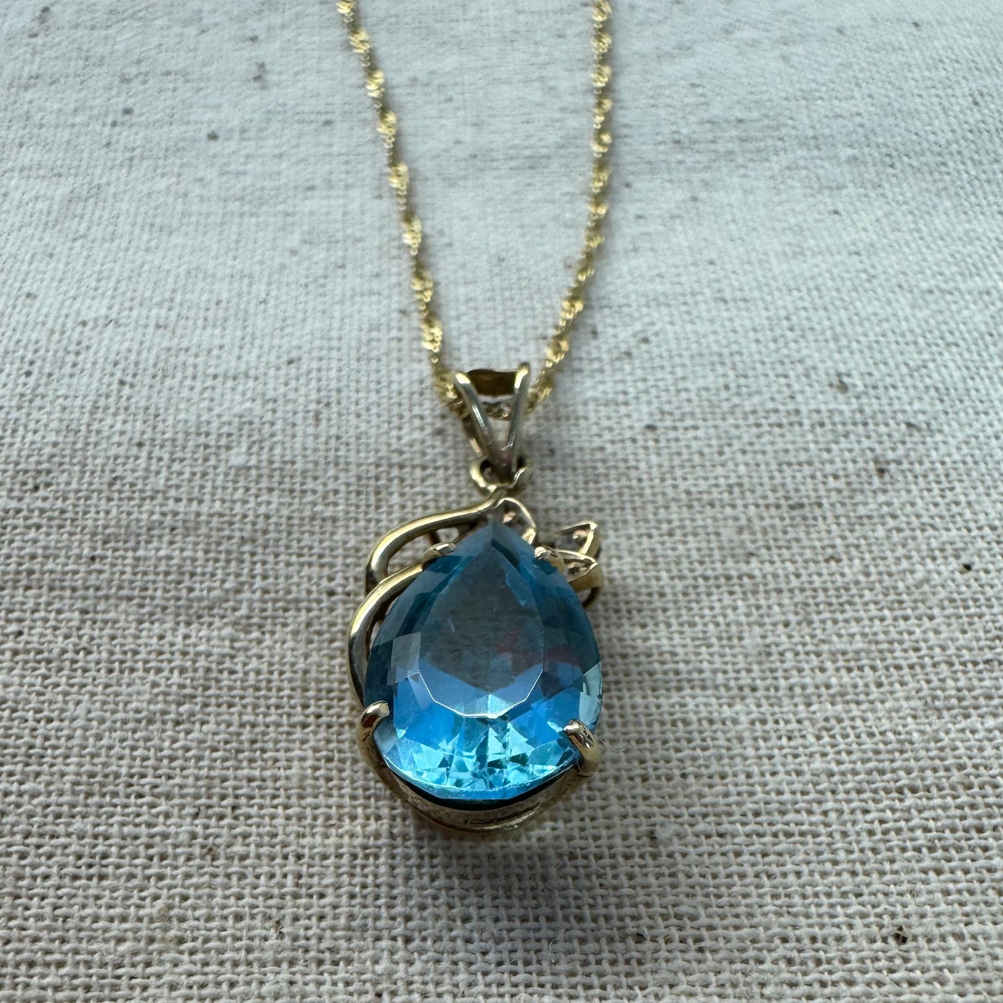 14K gold necklace set with Blue Topaz pendant in a teardrop cut